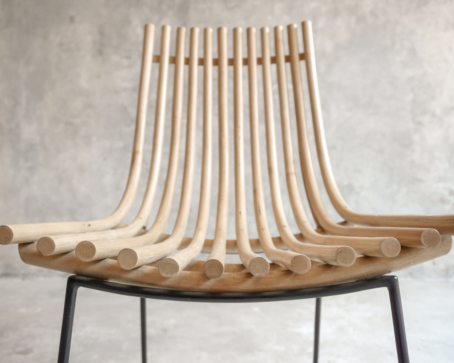 Wooden chair with curved back and black legs