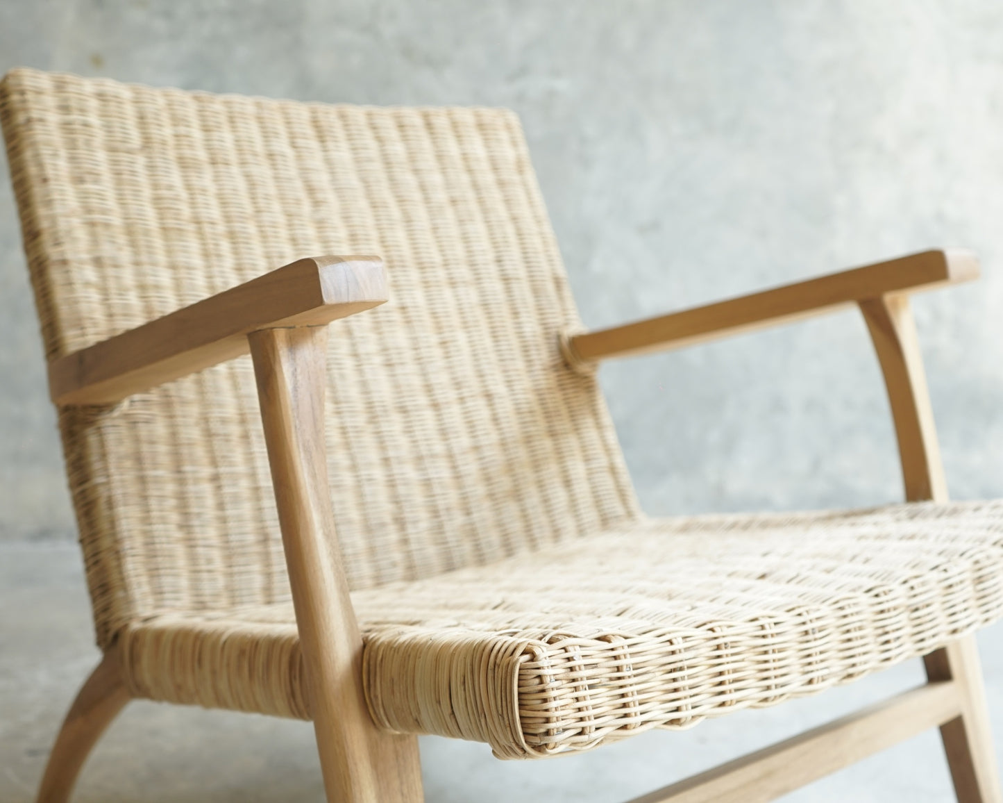 Wicker armchair with wooden arms