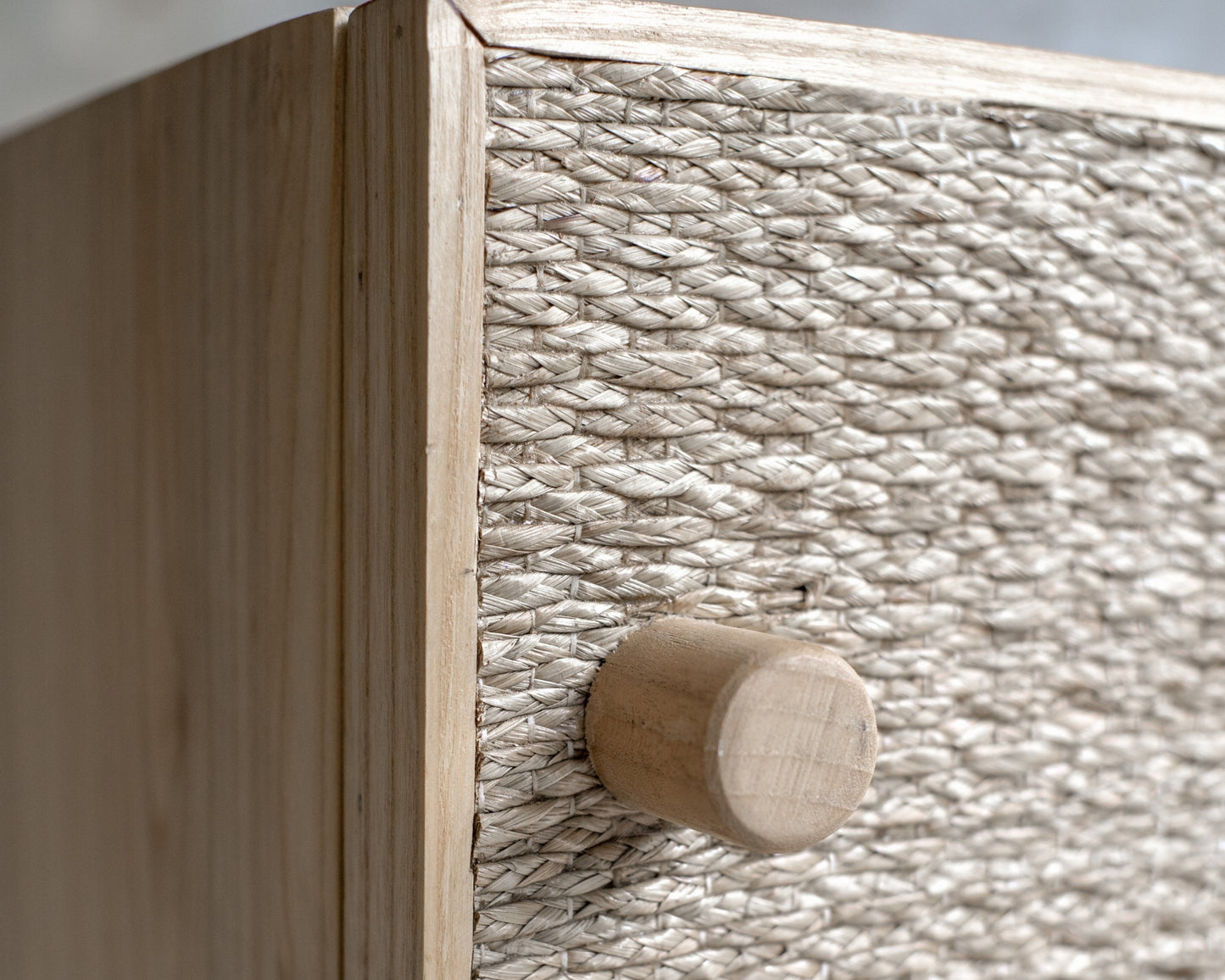 Close-up of woven cabinet with wooden knob