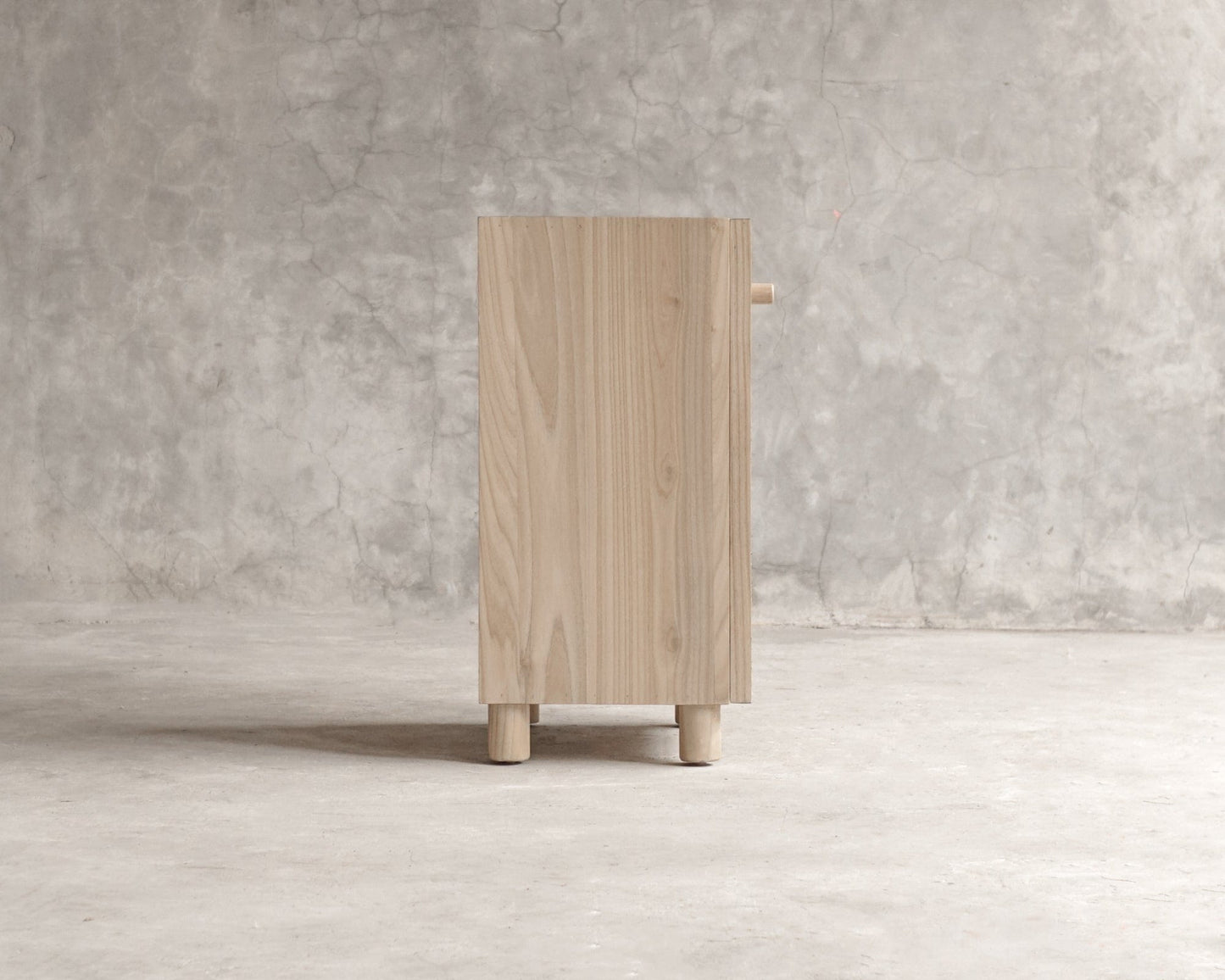 ELE119_5 Wooden cabinet side view against a concrete background