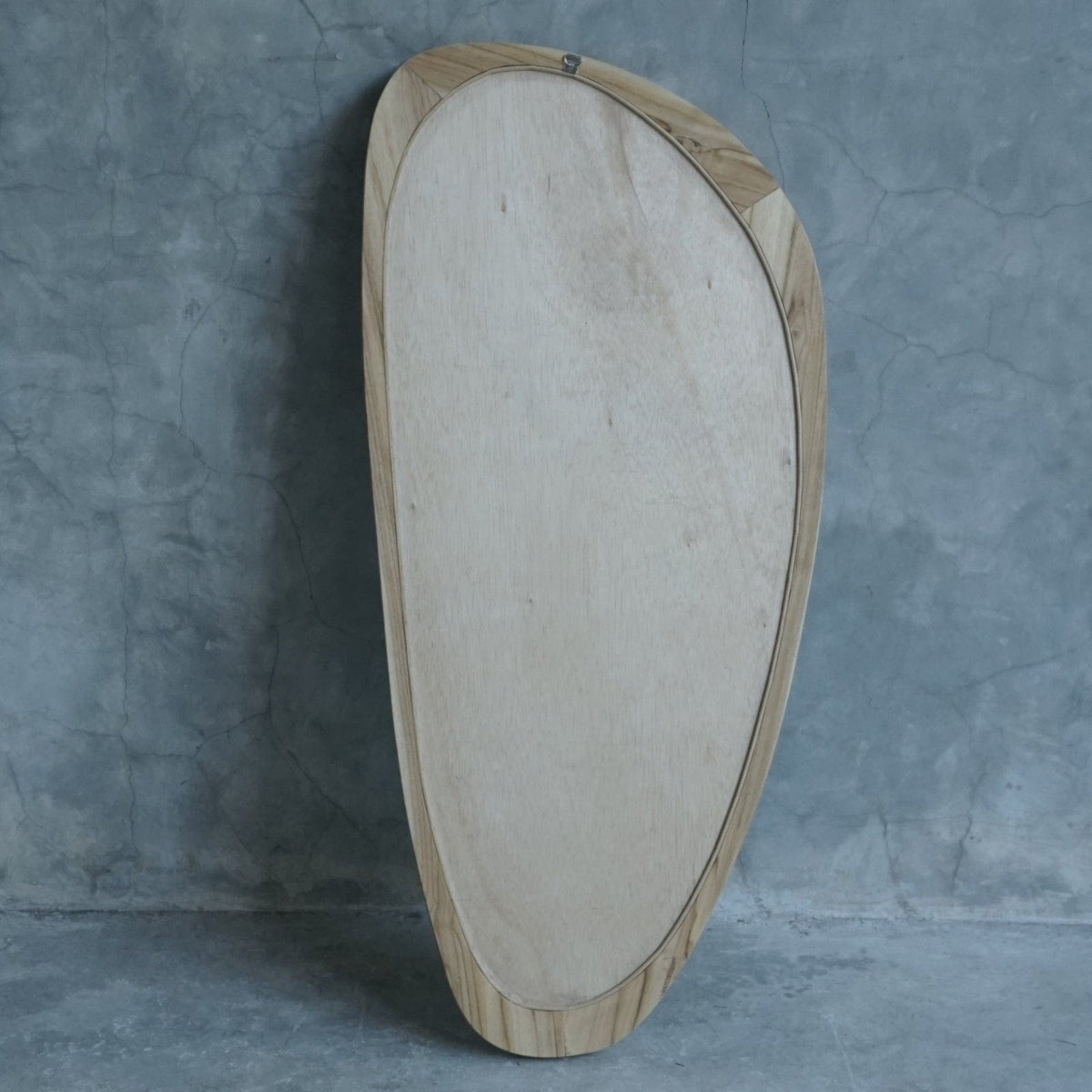 Modern wooden framed mirror against gray wall