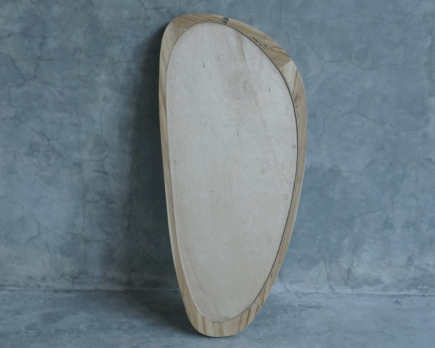 Modern wooden framed mirror against gray wall