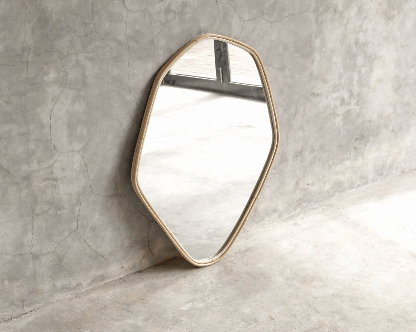 ELE124 Mirror - Modern geometric wall mirror against a concrete wall.