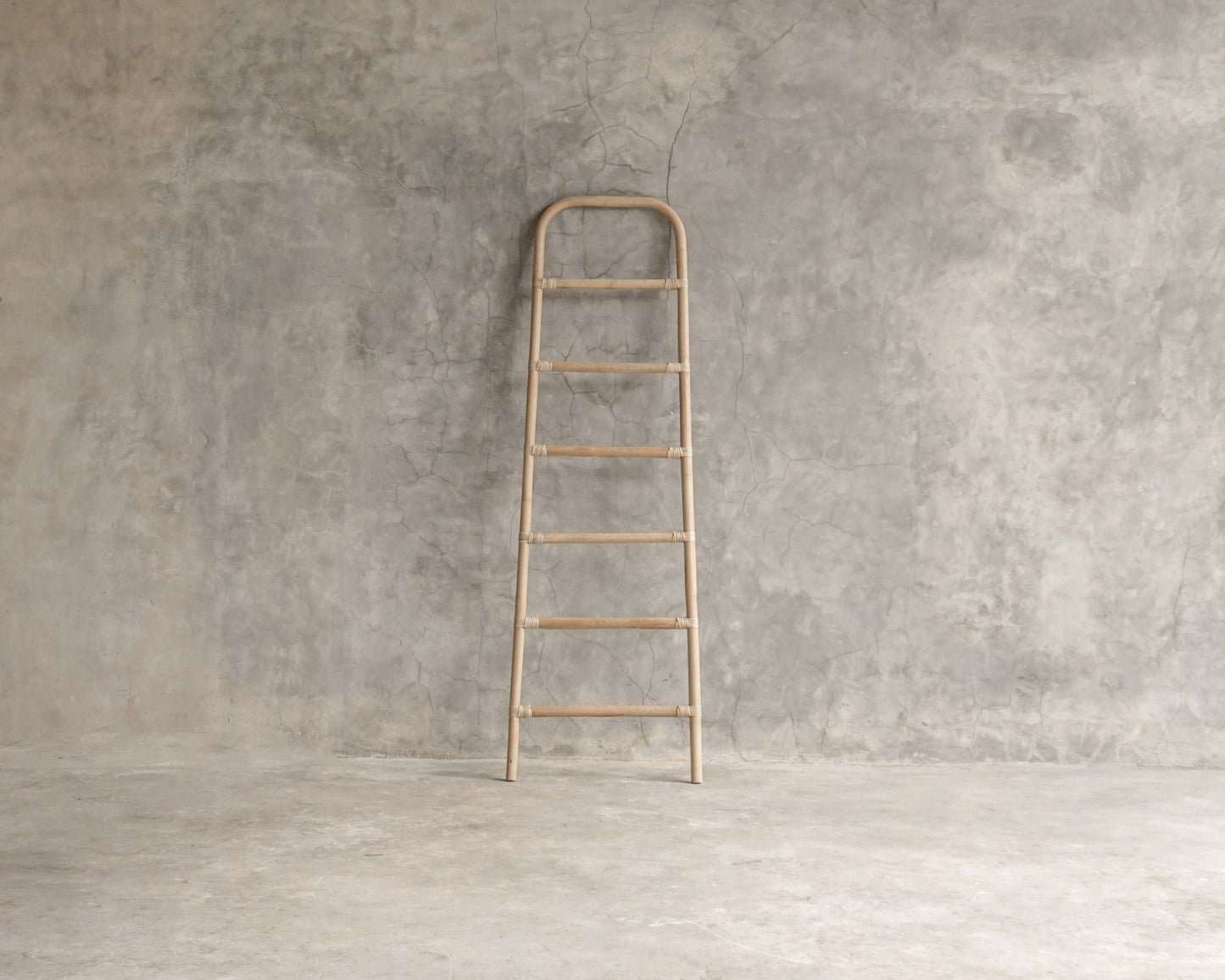 Wooden ladder against concrete wall