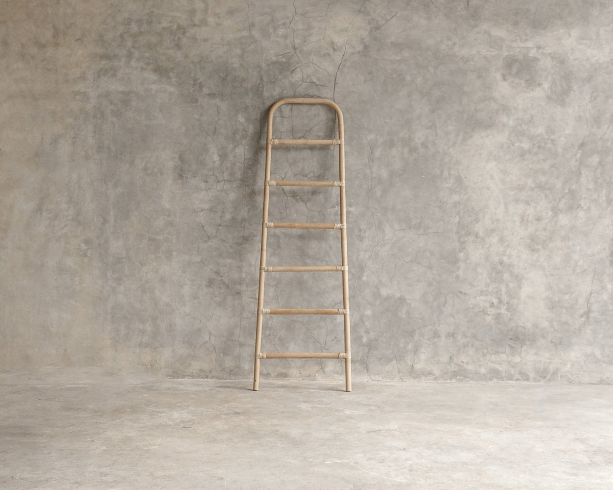 Wooden ladder against concrete wall