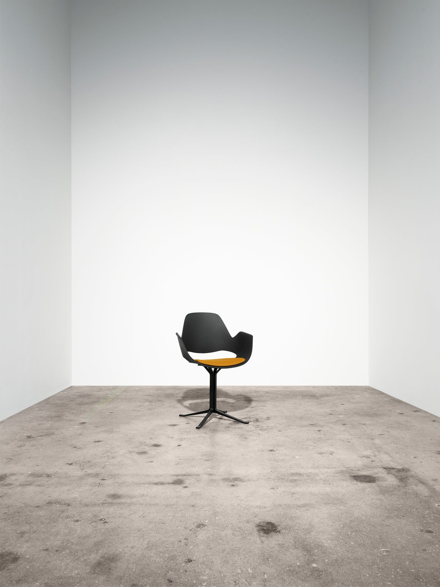FALK Chair by HOUE with dark-yellow upholstered seat in a minimalist space