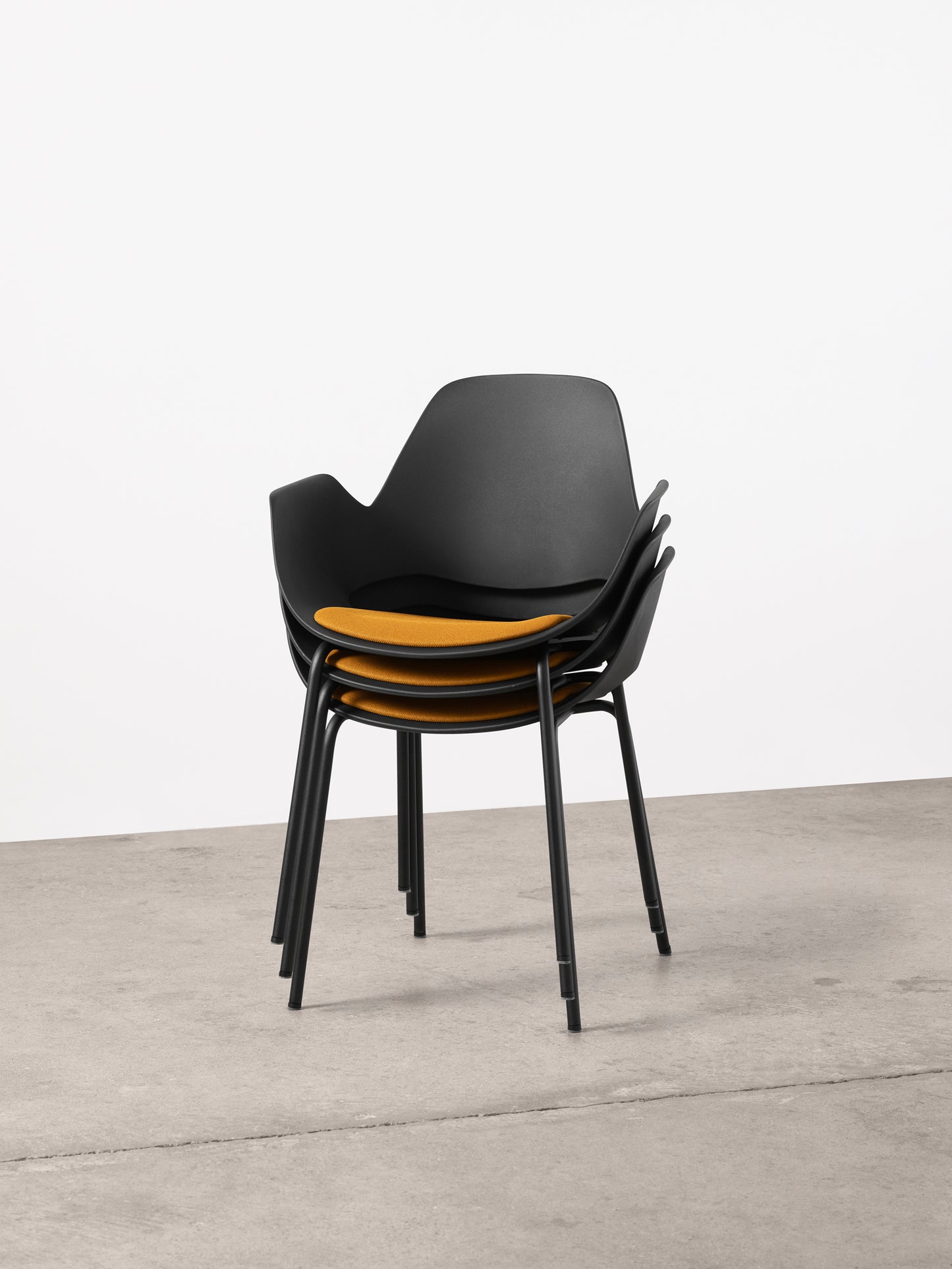 Stacked black FALK chair with dark yellow seat