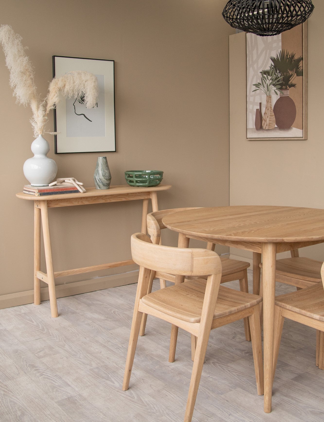 Black and white dining room with wooden furniture and art.