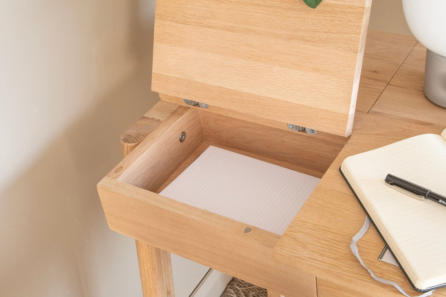 Wooden desk with open drawer and notebook