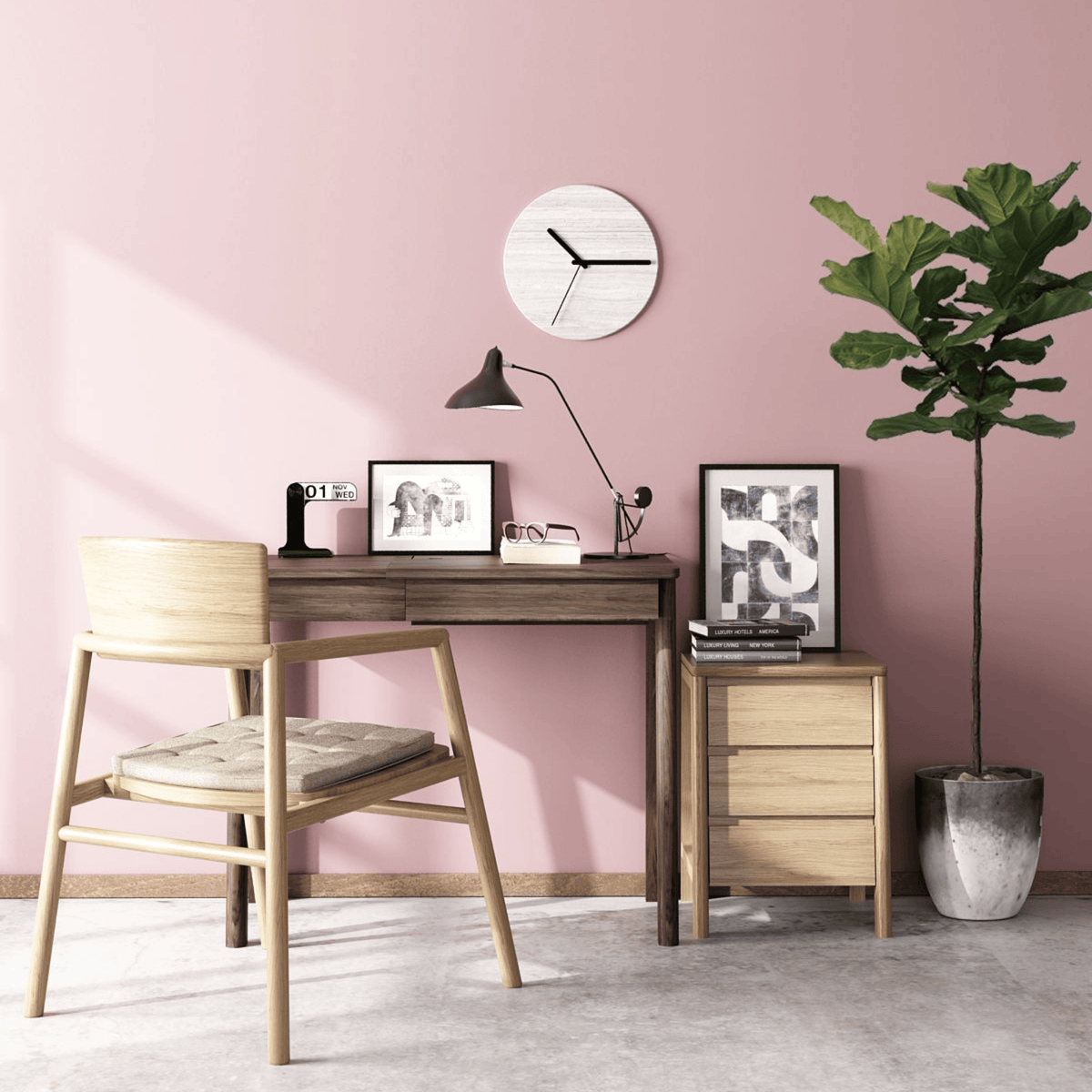 Pink office desk with chair, clock, and plant.