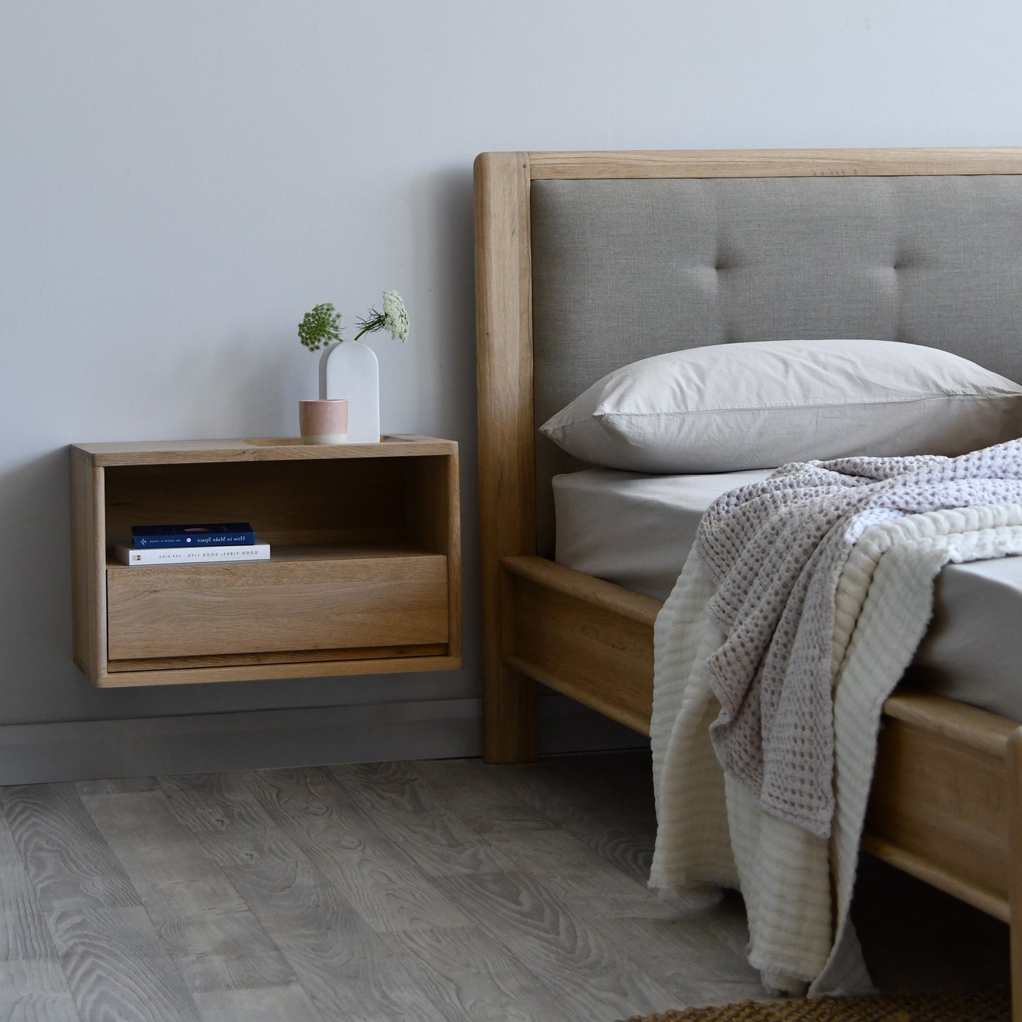Floating Scandinavian Oak Wood Bedside on the left side of the bed with a king size bed frame next to it