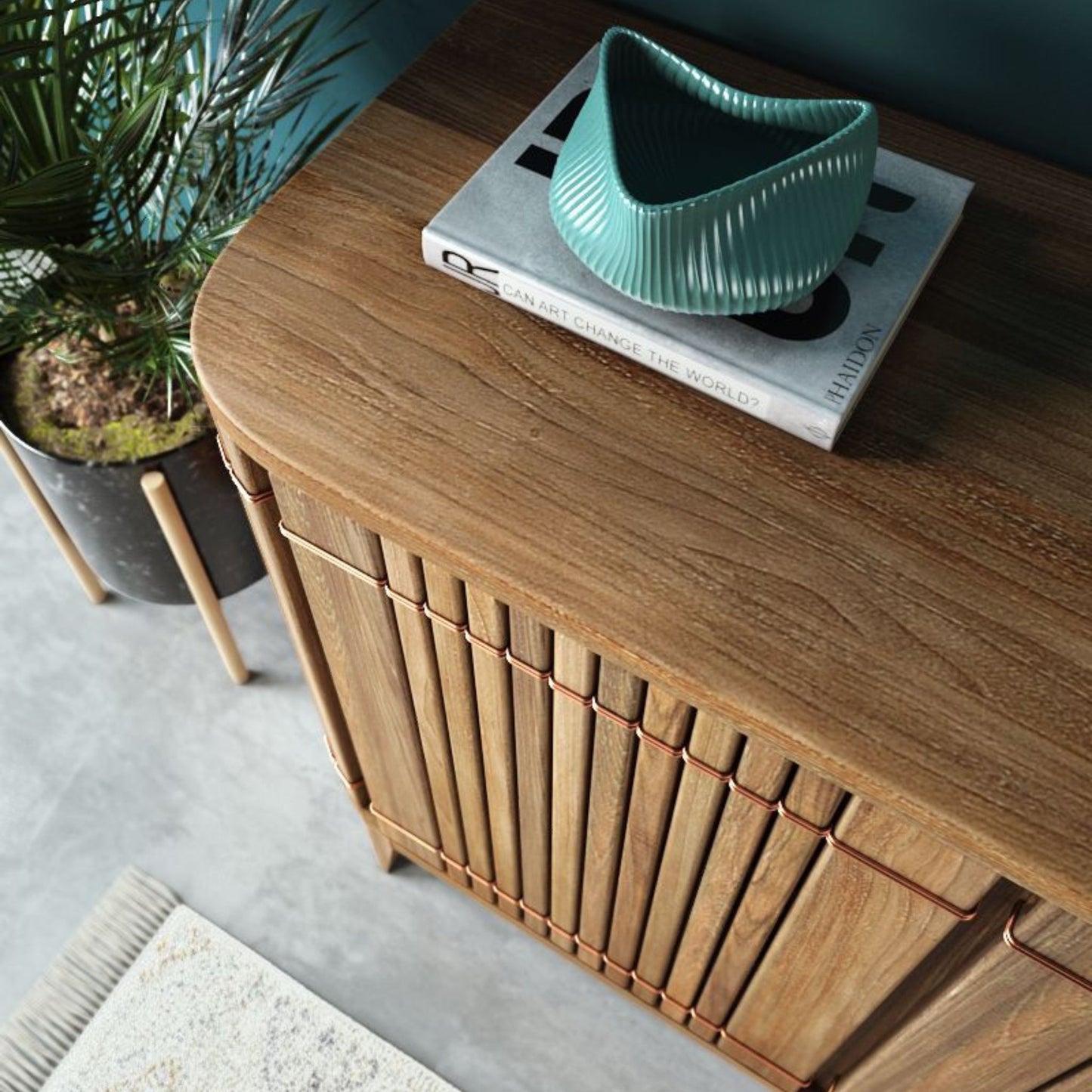 Wooden cabinet with decor, teal vase, and plant