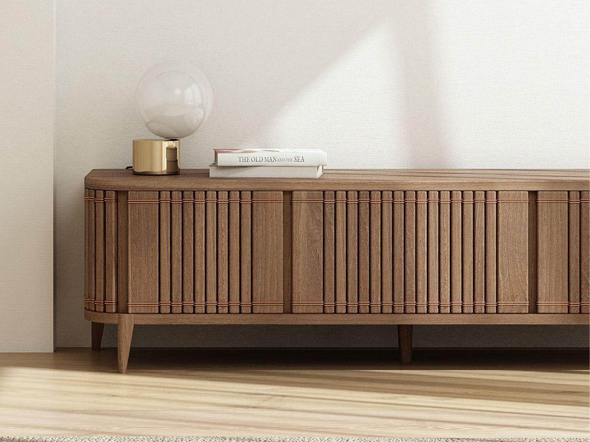 Wooden media console with lamp and books