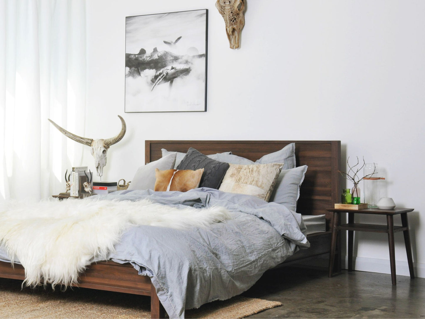 Modern bedroom with art and fur throw