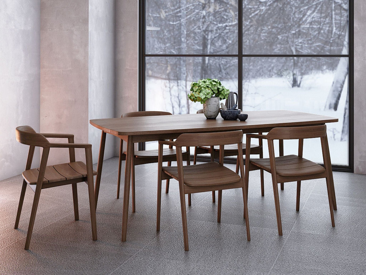 Wooden dining table and chairs with a winter view.
