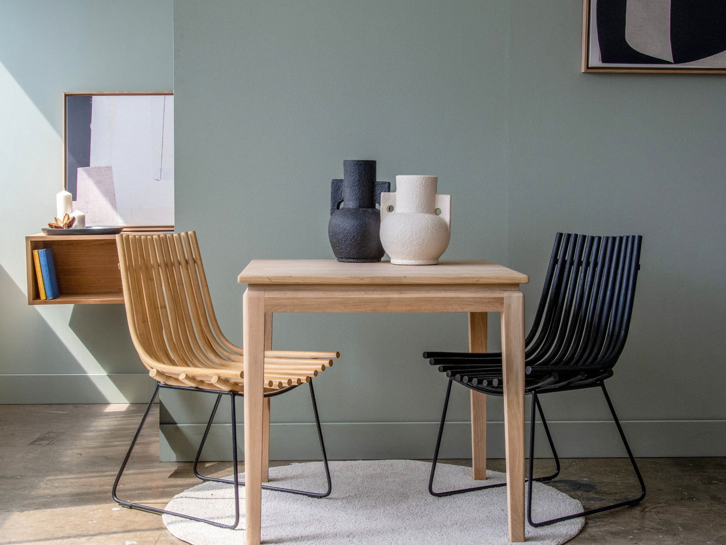 Dining room with table, chairs, and vases.