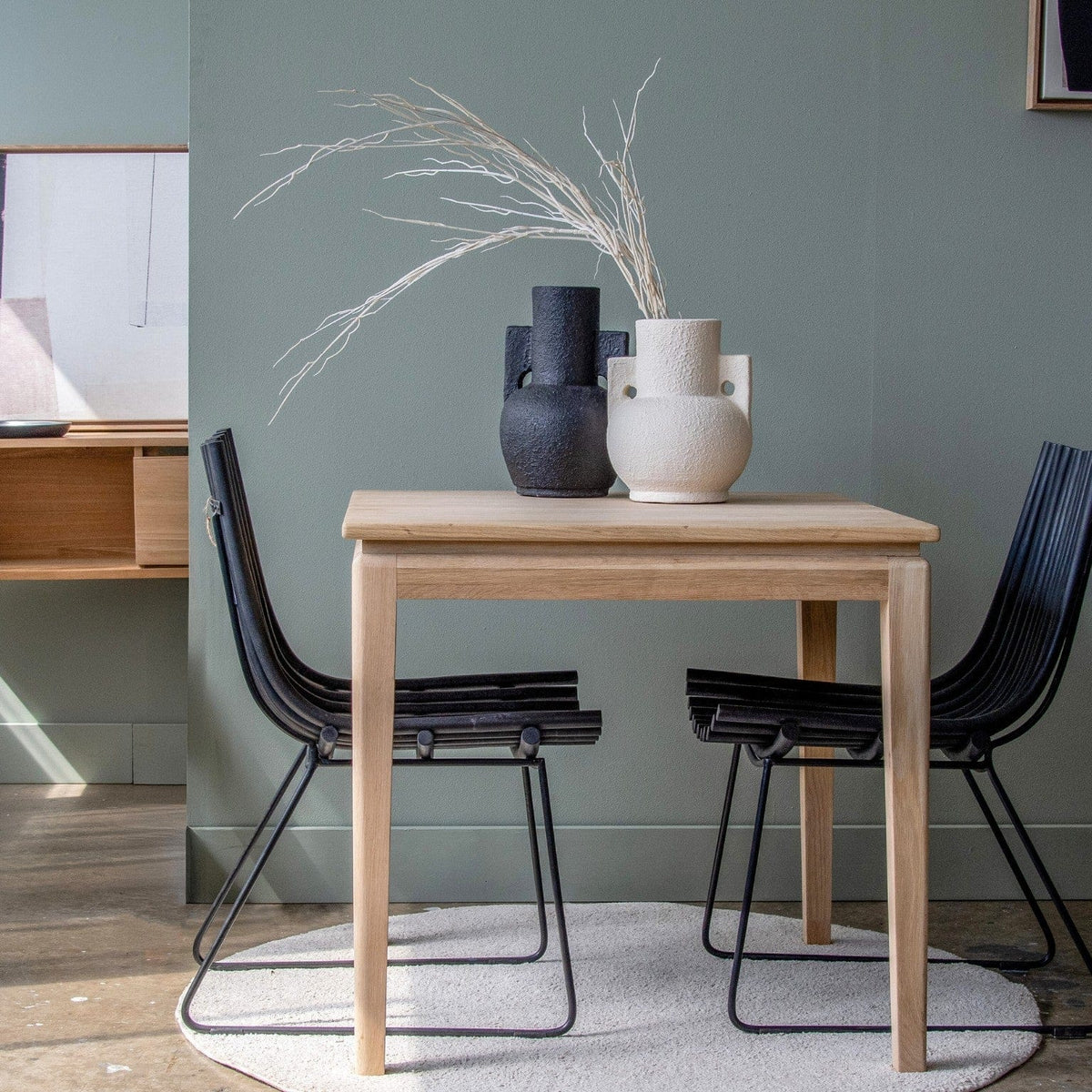 Modern dining table set with vases and chairs
