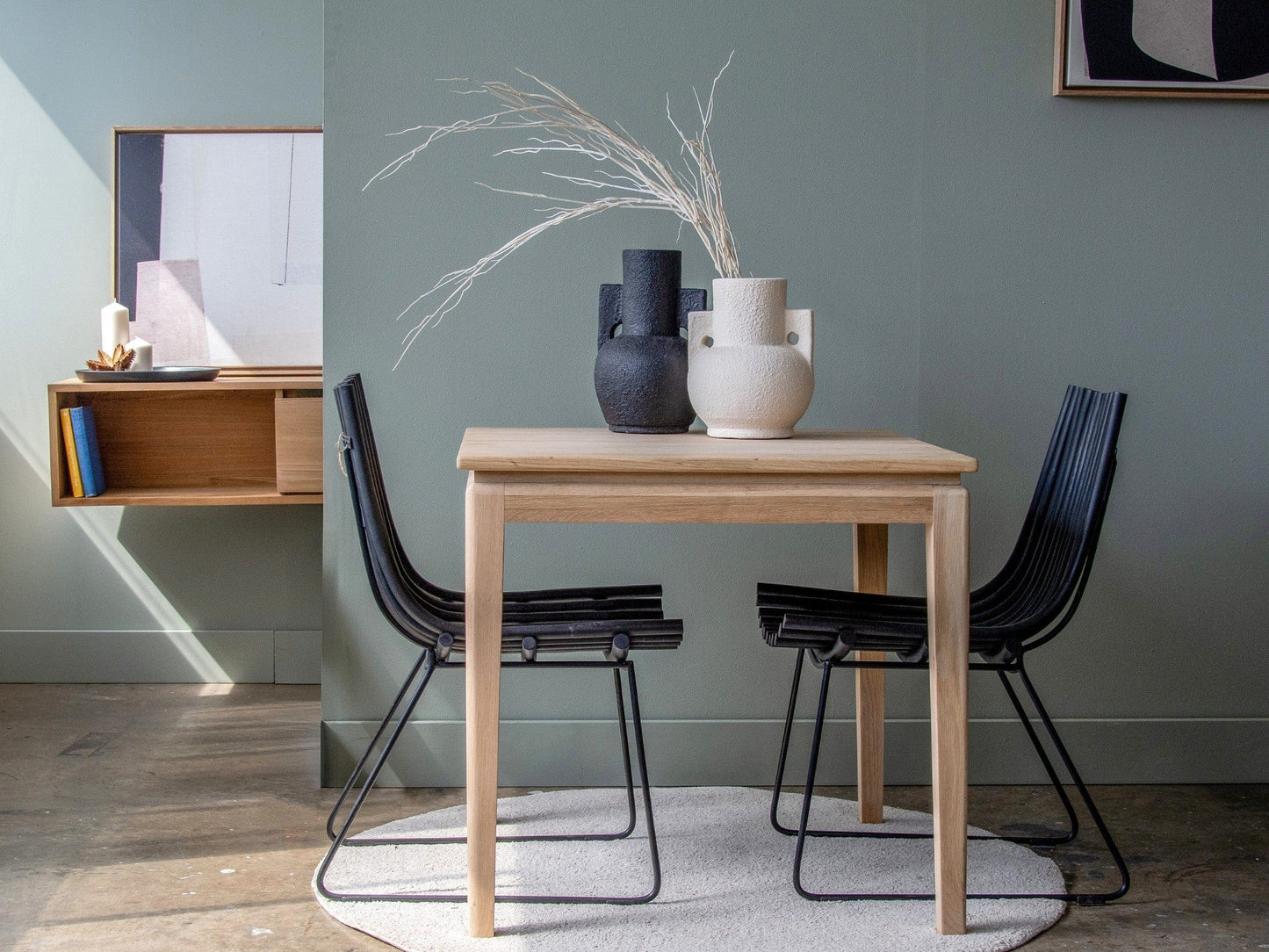 Modern dining table set with vases and chairs