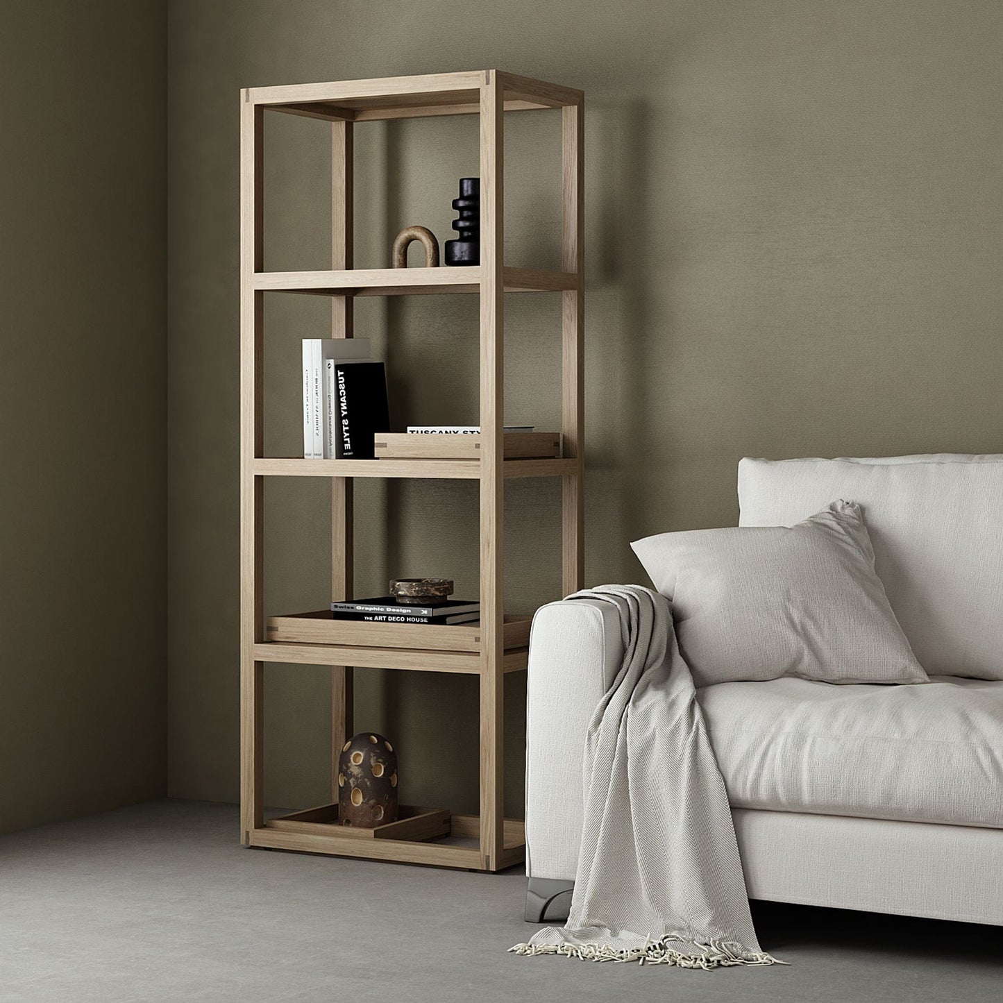 Wooden bookshelf with decor next to white sofa