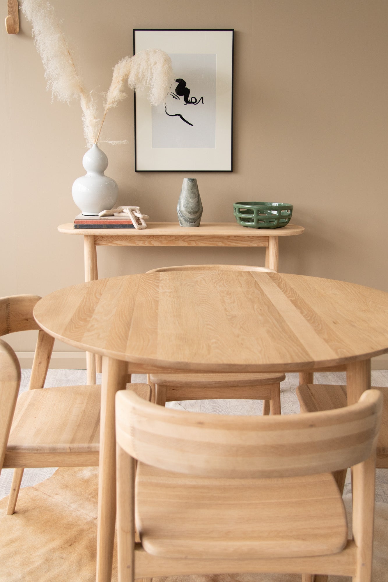Wooden table and chairs with art and decor