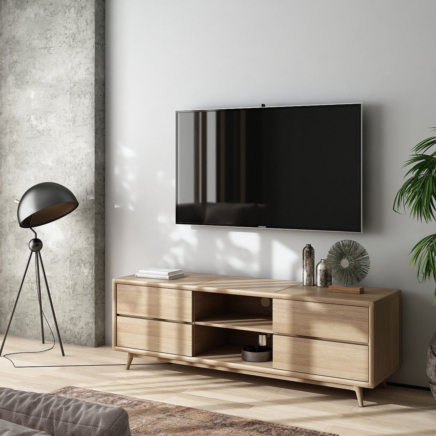 Modern TV stand with mounted television and decor