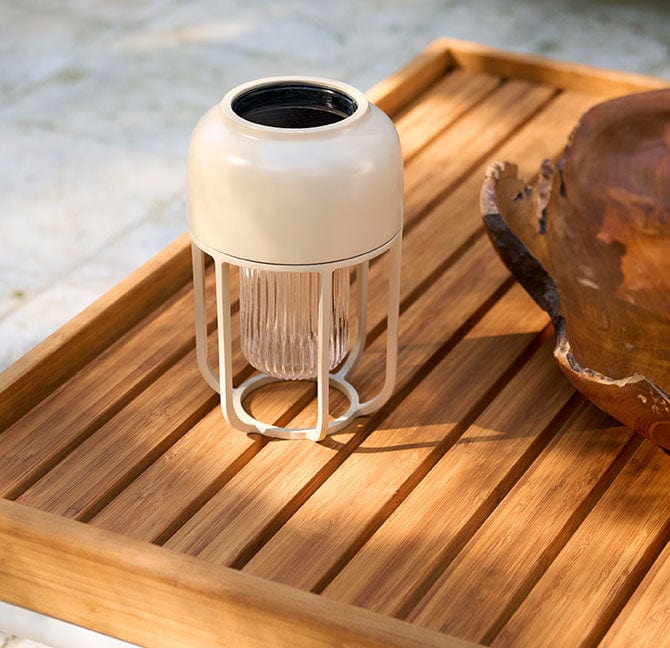 Beige lantern on wooden tray