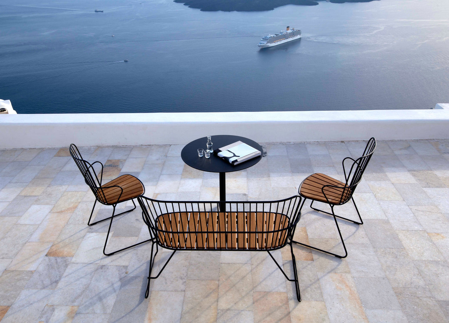 Patio furniture with ocean view and cruise ship