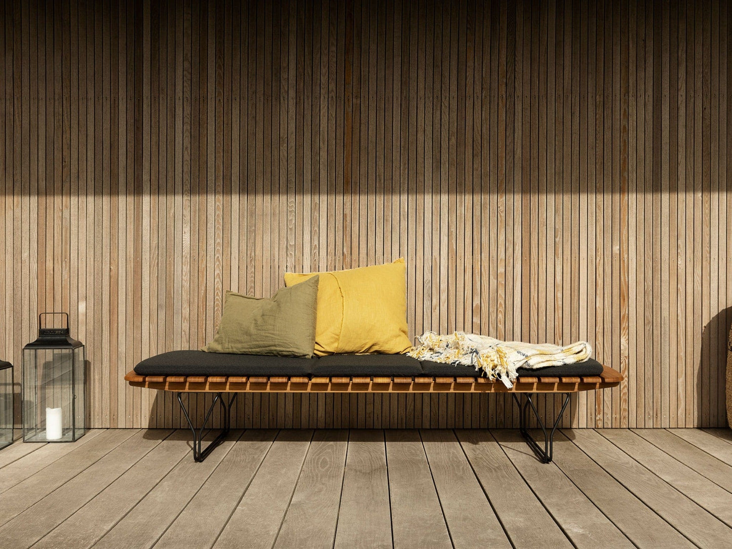 Molo Charcoal bench with pillows on wooden deck