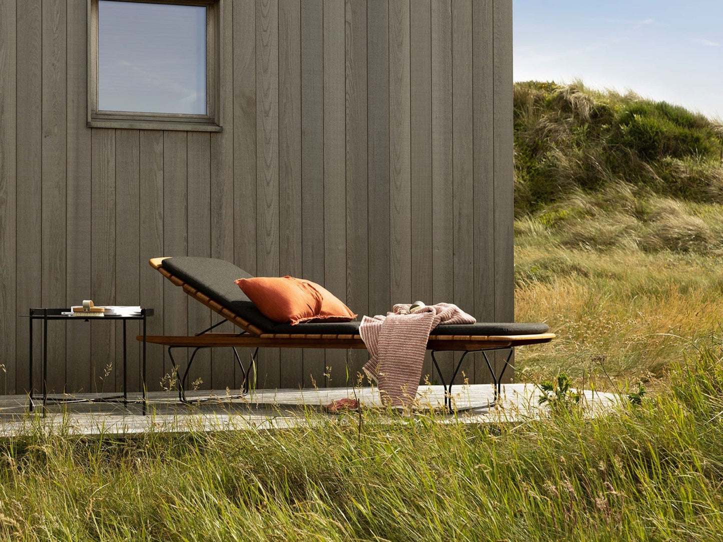 Molo charcoal outdoor chaise lounge with pillow and blanket