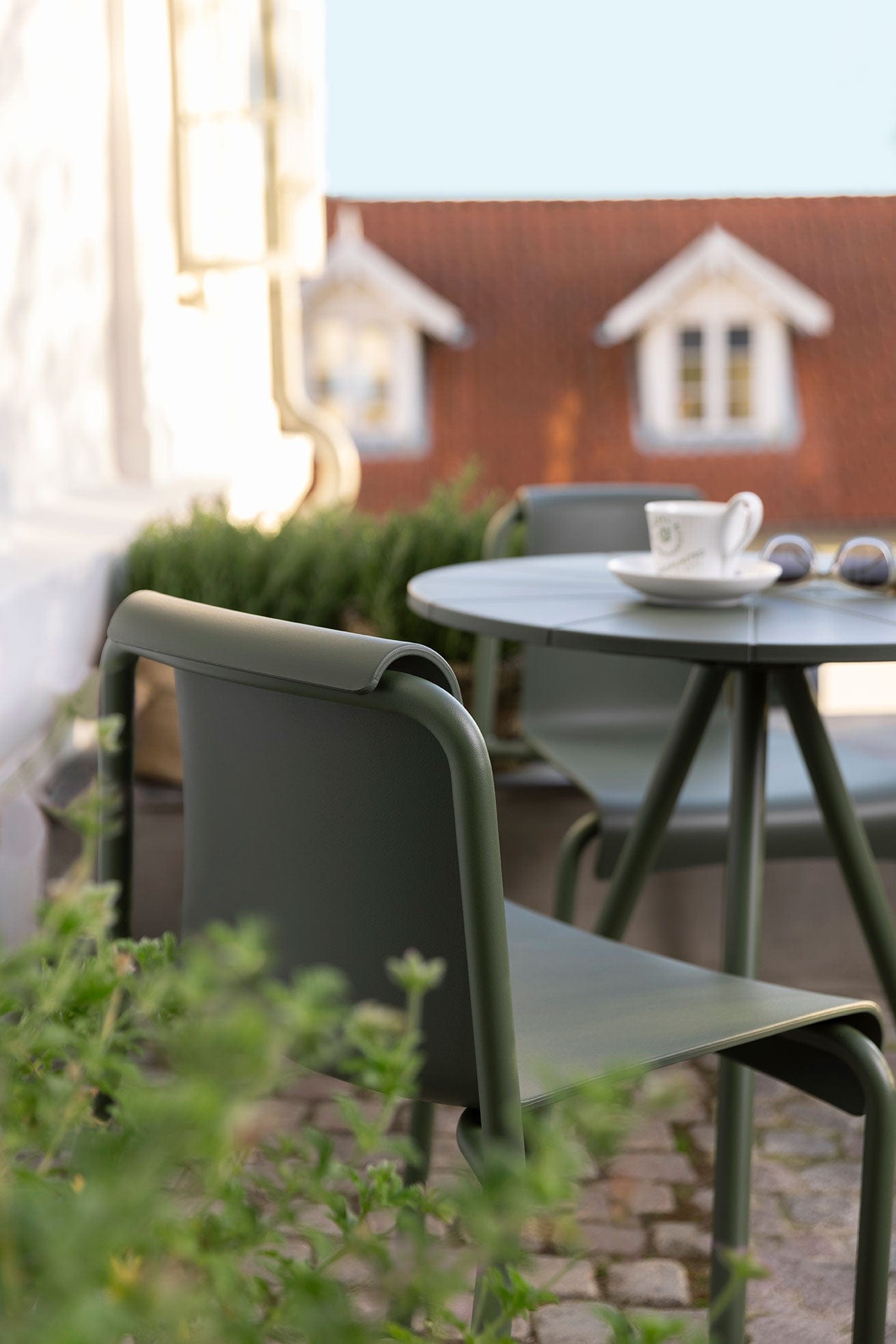 Olive green Houe cafe table and chair closeup