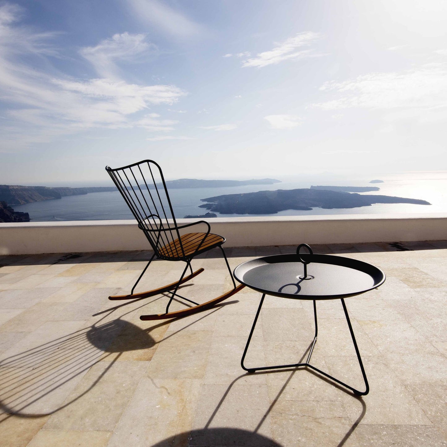 PAON rocking chair with cushion and side table overlooking ocean