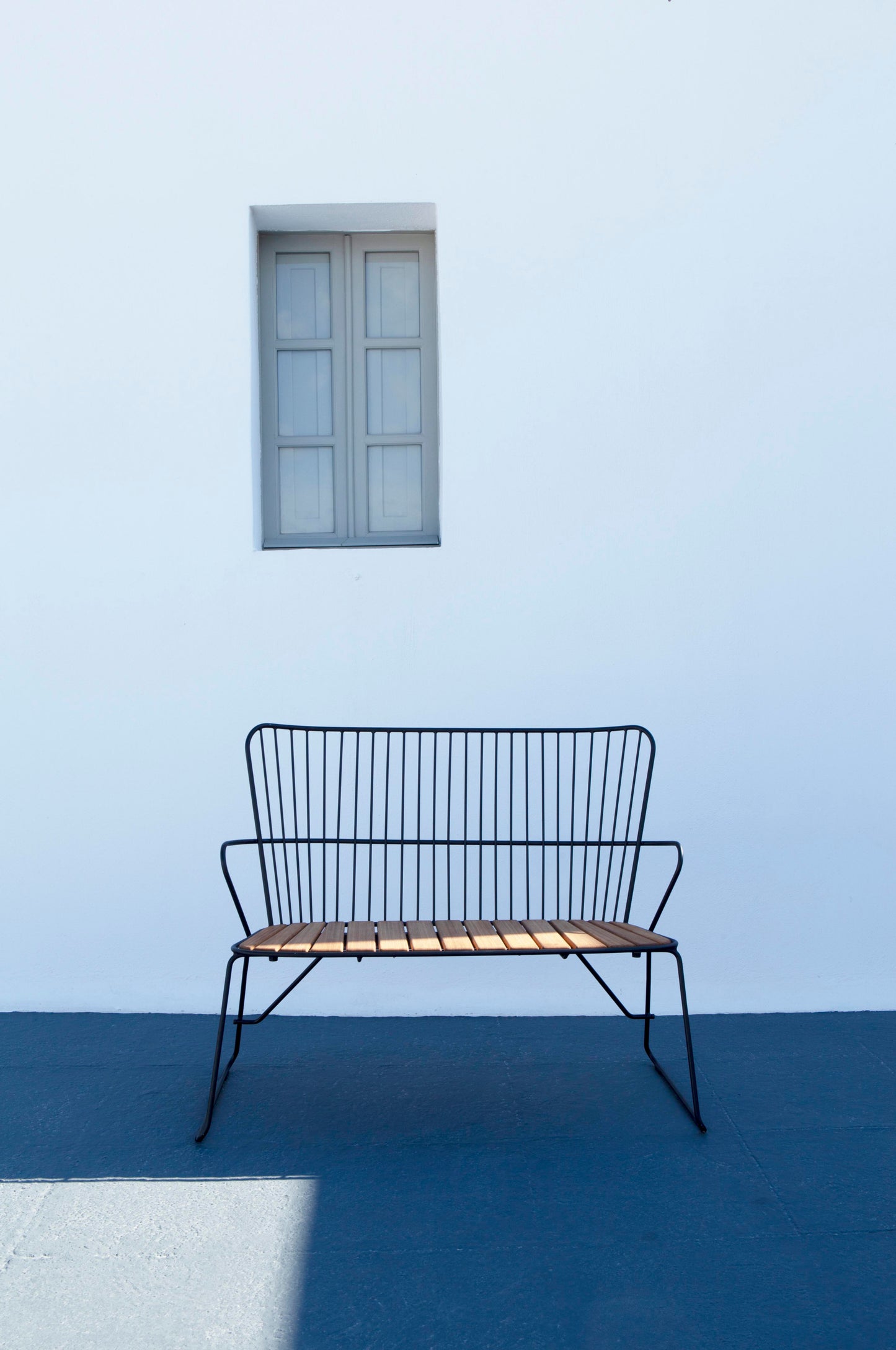 Black HOUE PAON bench in front of white wall and window