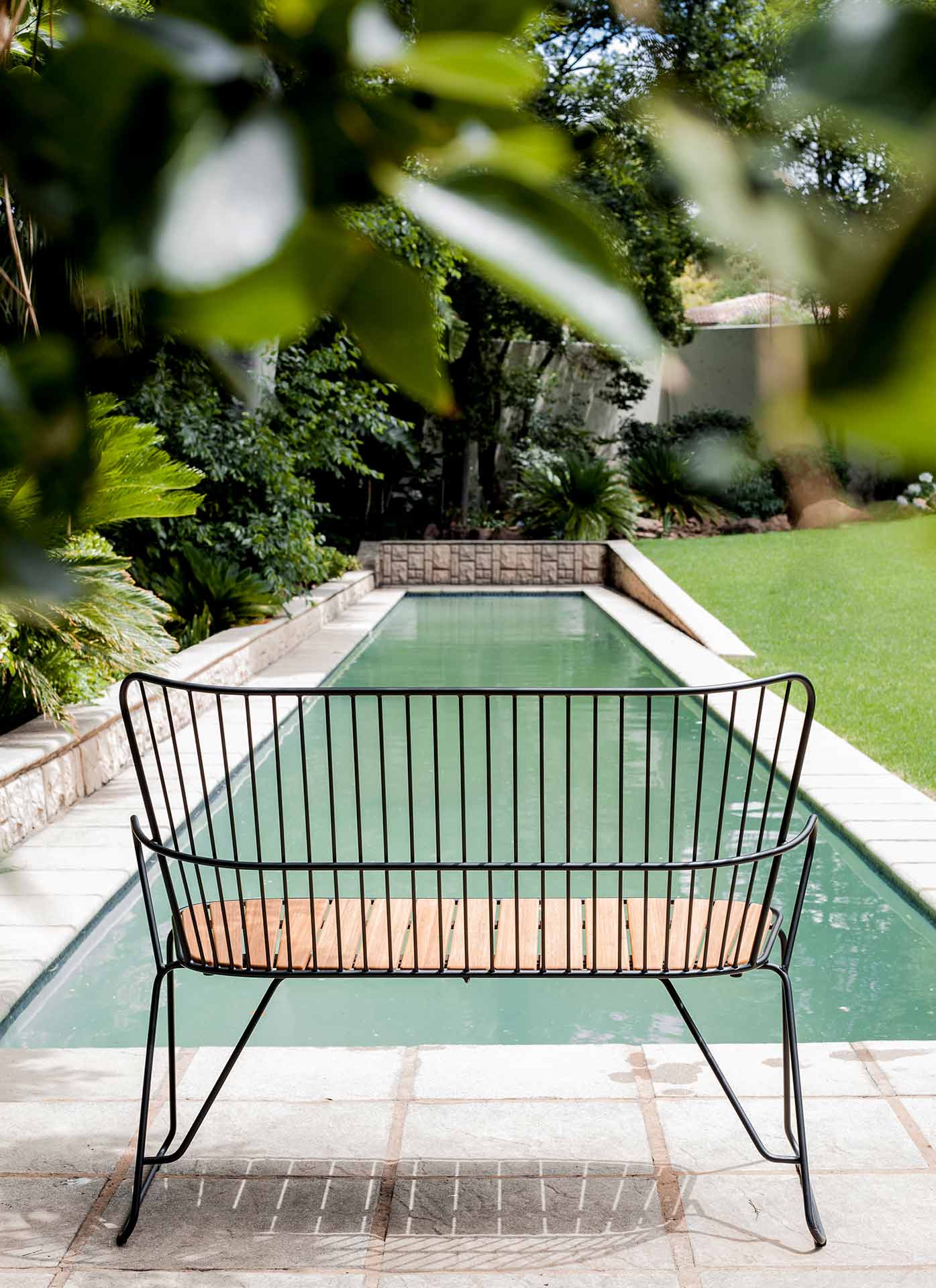 Black HOUE bench by pool