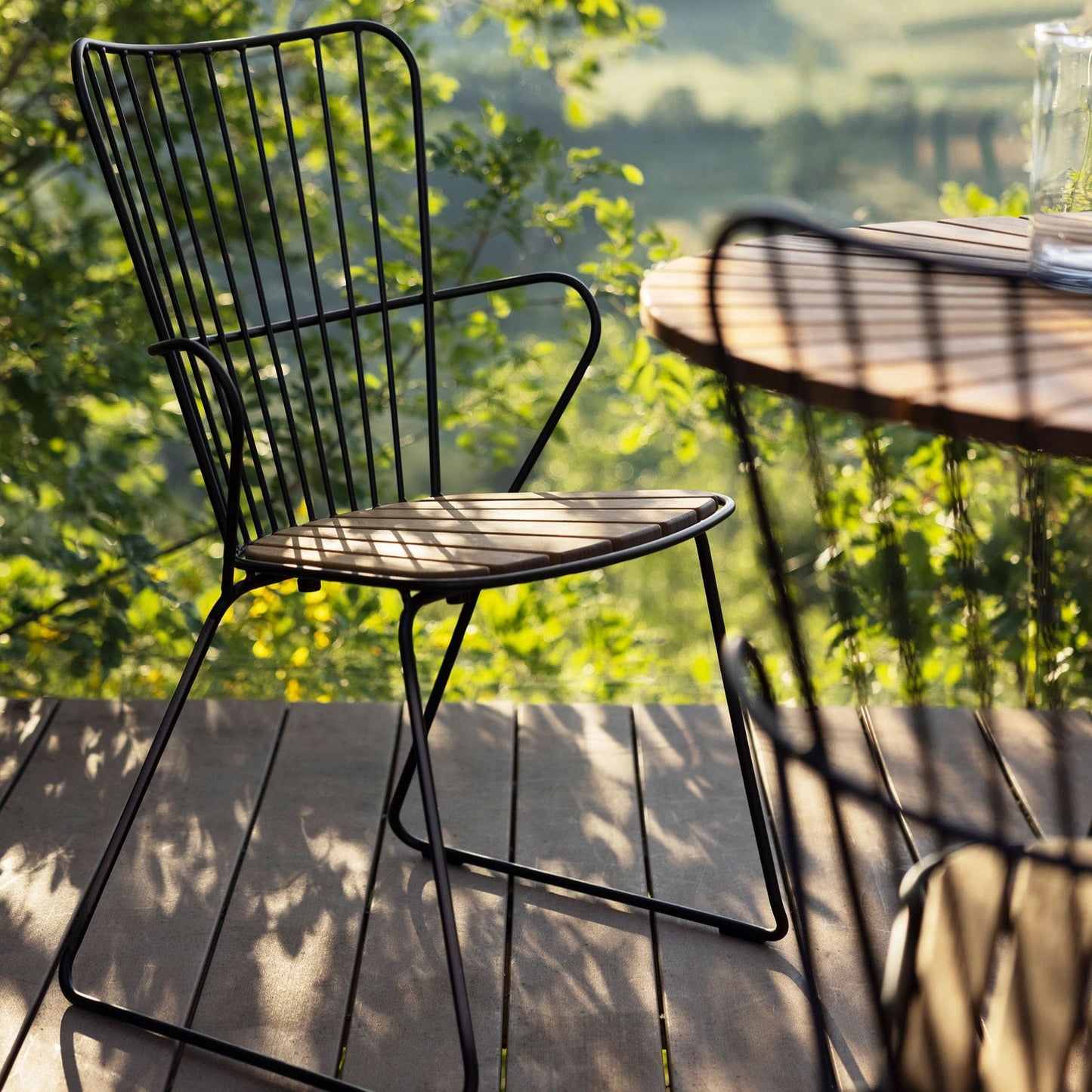 Black PAON dining chair on outdoor deck