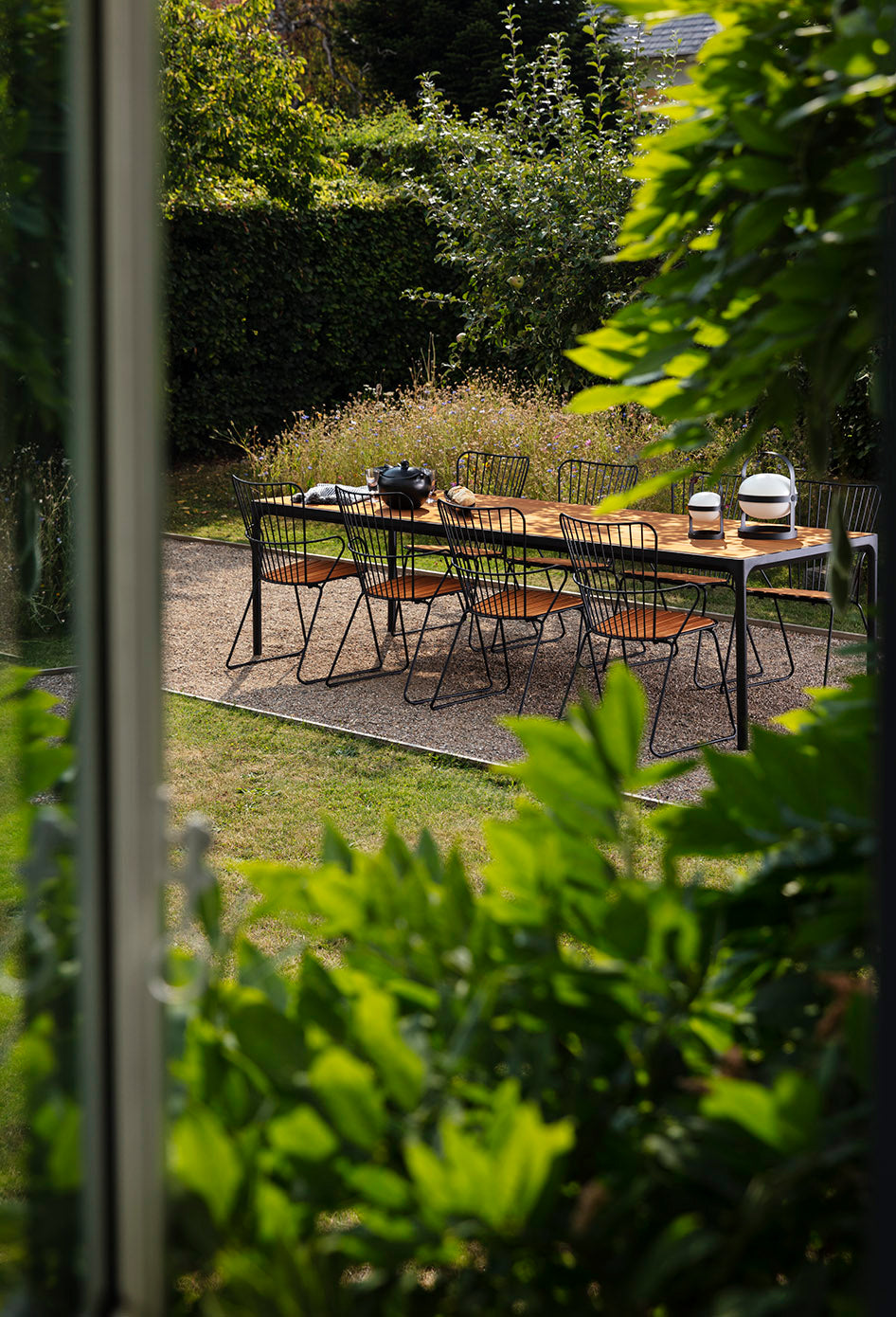 PAON black bamboo dining table set for four, outdoor patio.