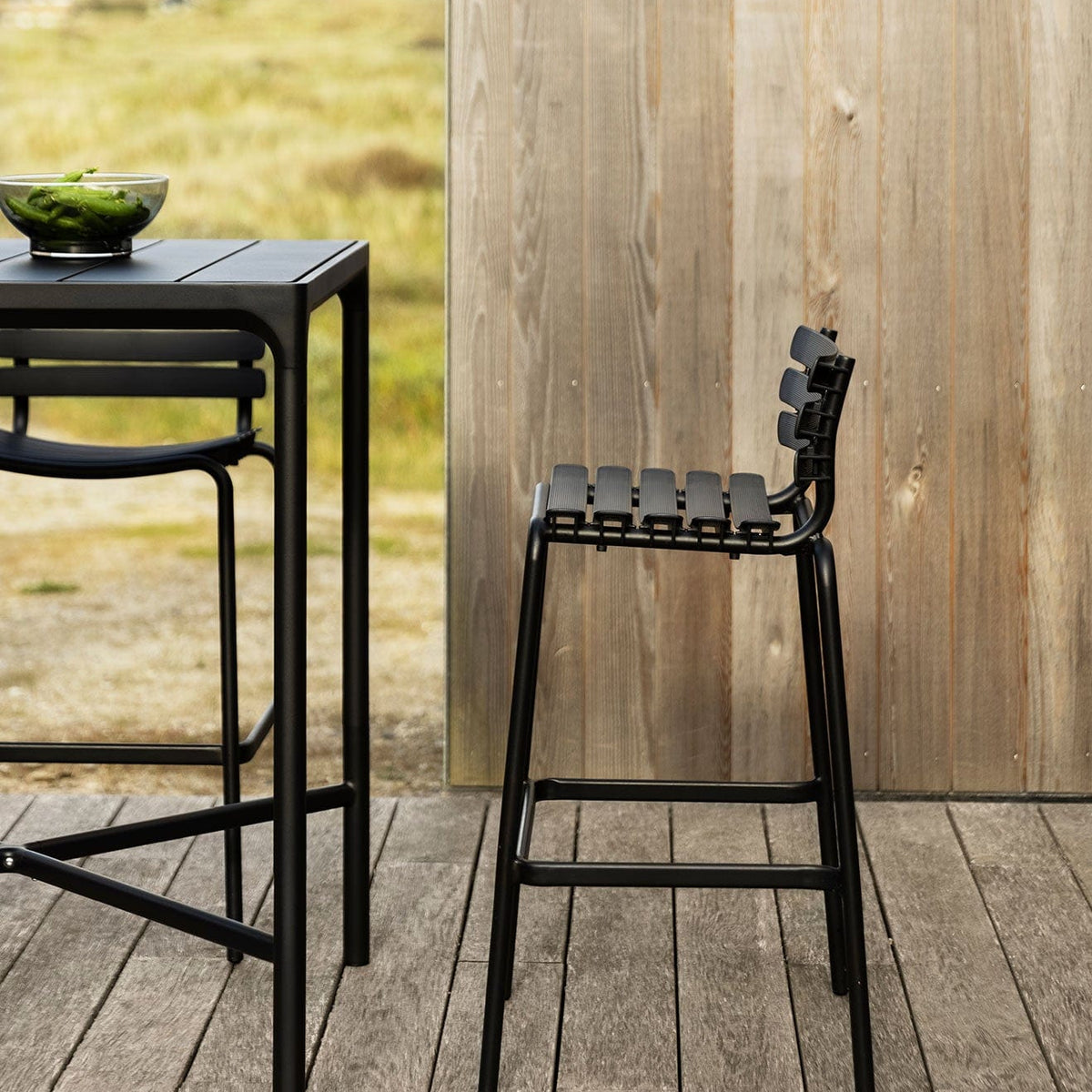 Black ReCLIPS bar stool and table on outdoor deck