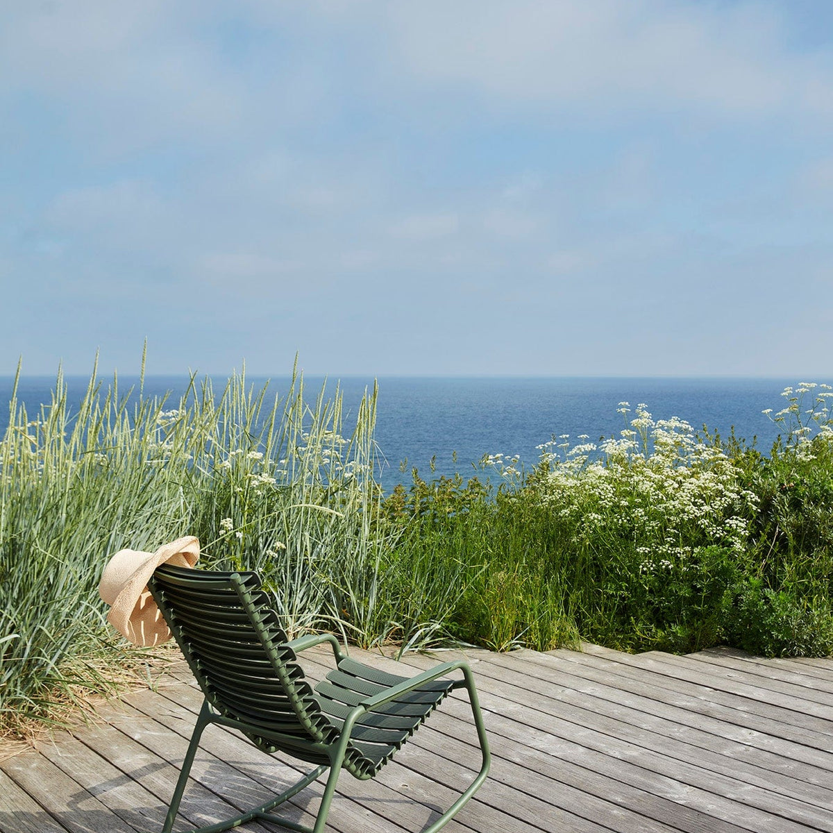 ReCLIPS olive green rocking chair by HOUE on deck overlooking ocean