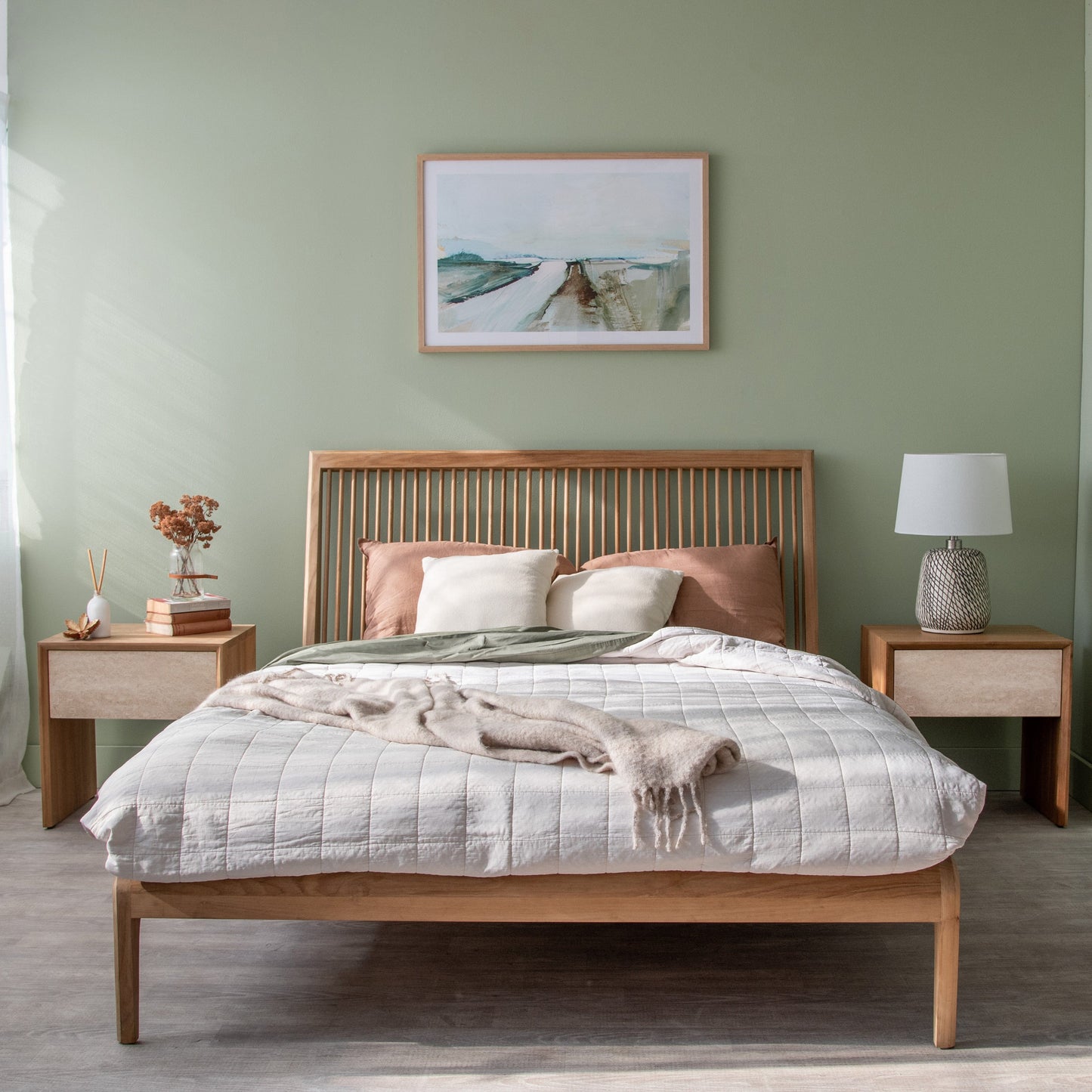Wooden bed with mixed bedside tables in a bedroom.