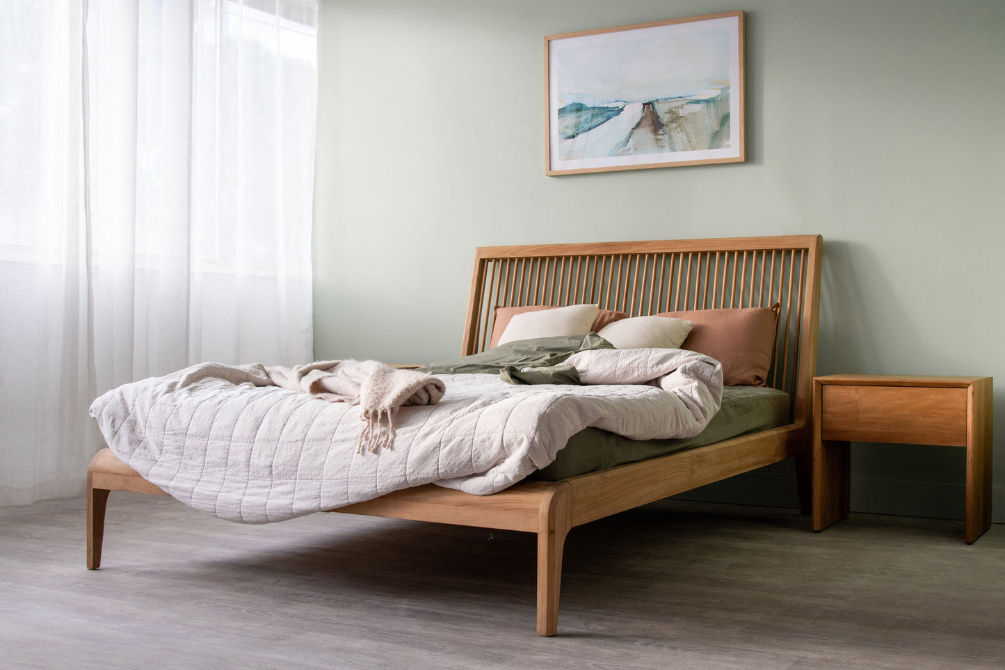 Bedroom with wooden bed frame and curtain