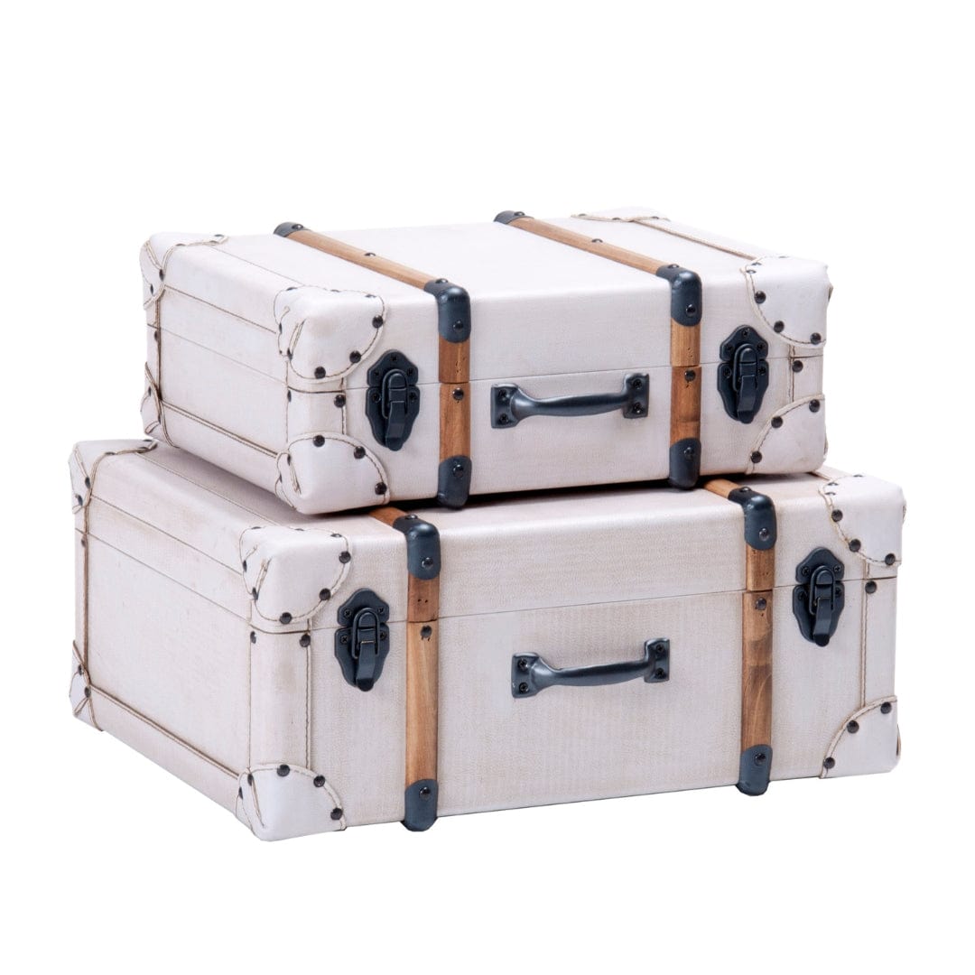 Stacked white vintage suitcases
