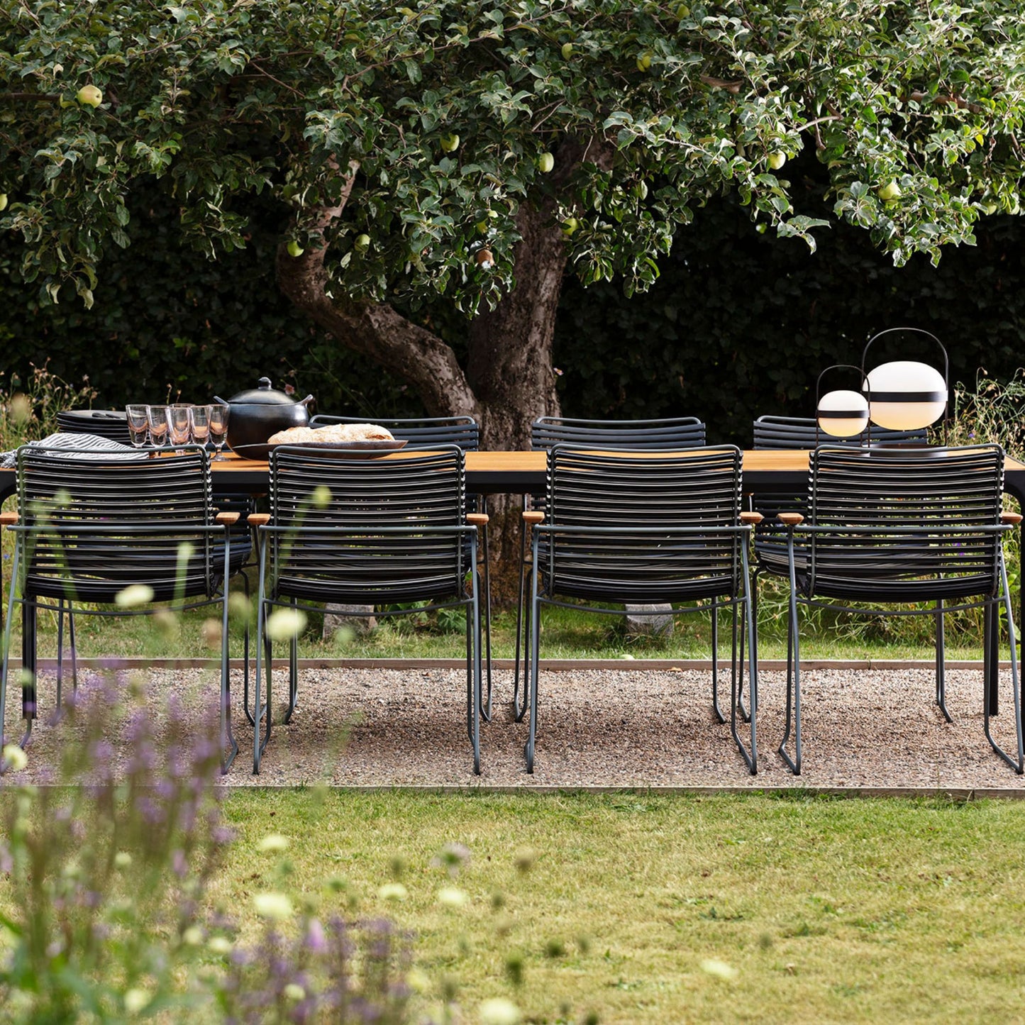 Black click four-table set with chairs under tree