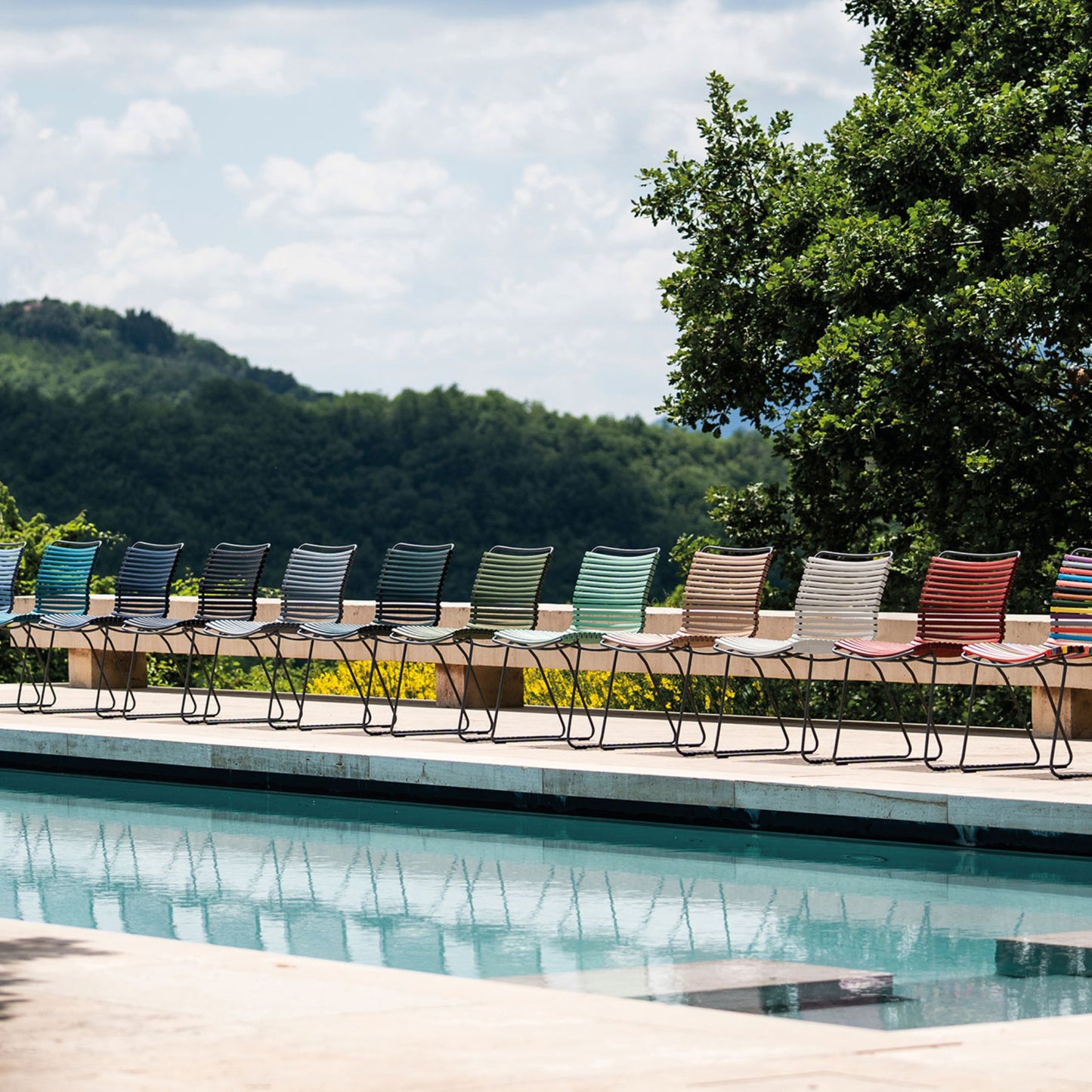Colorful armless outdoor chairs by pool