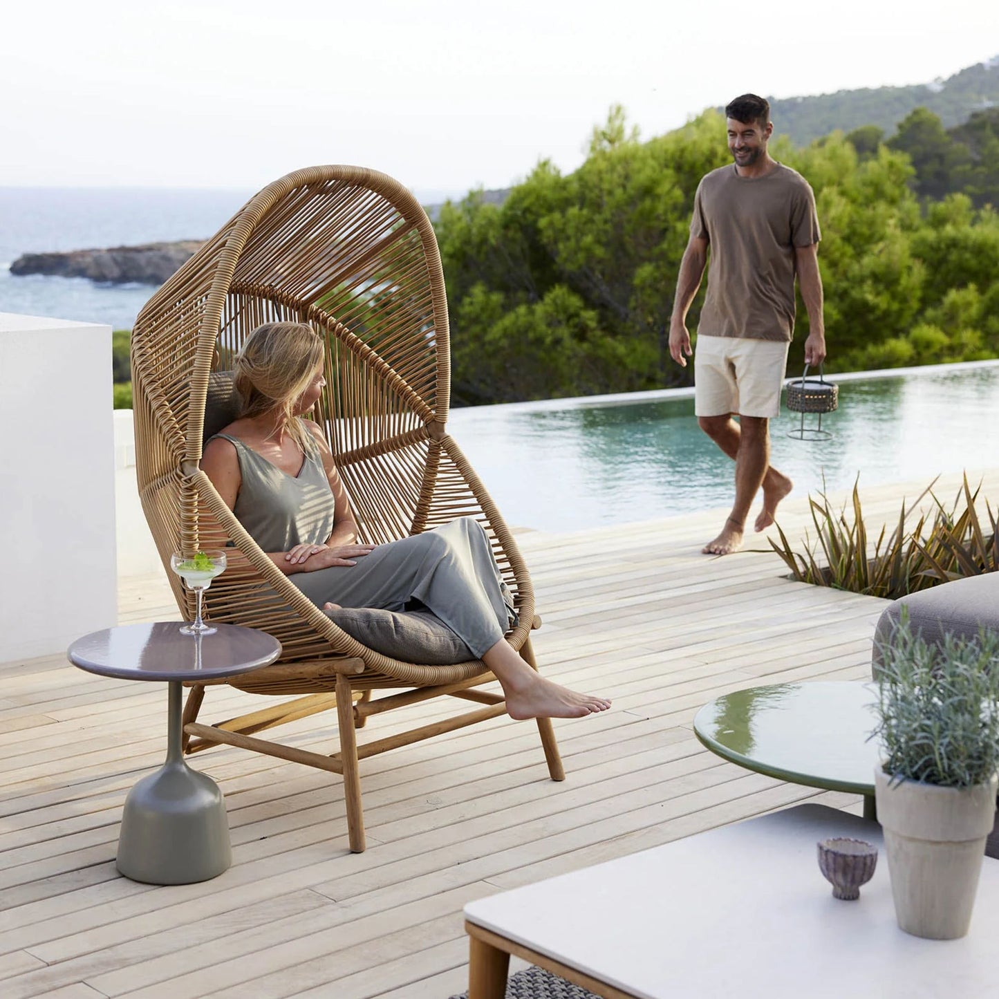 Hive chair on patio with person near pool