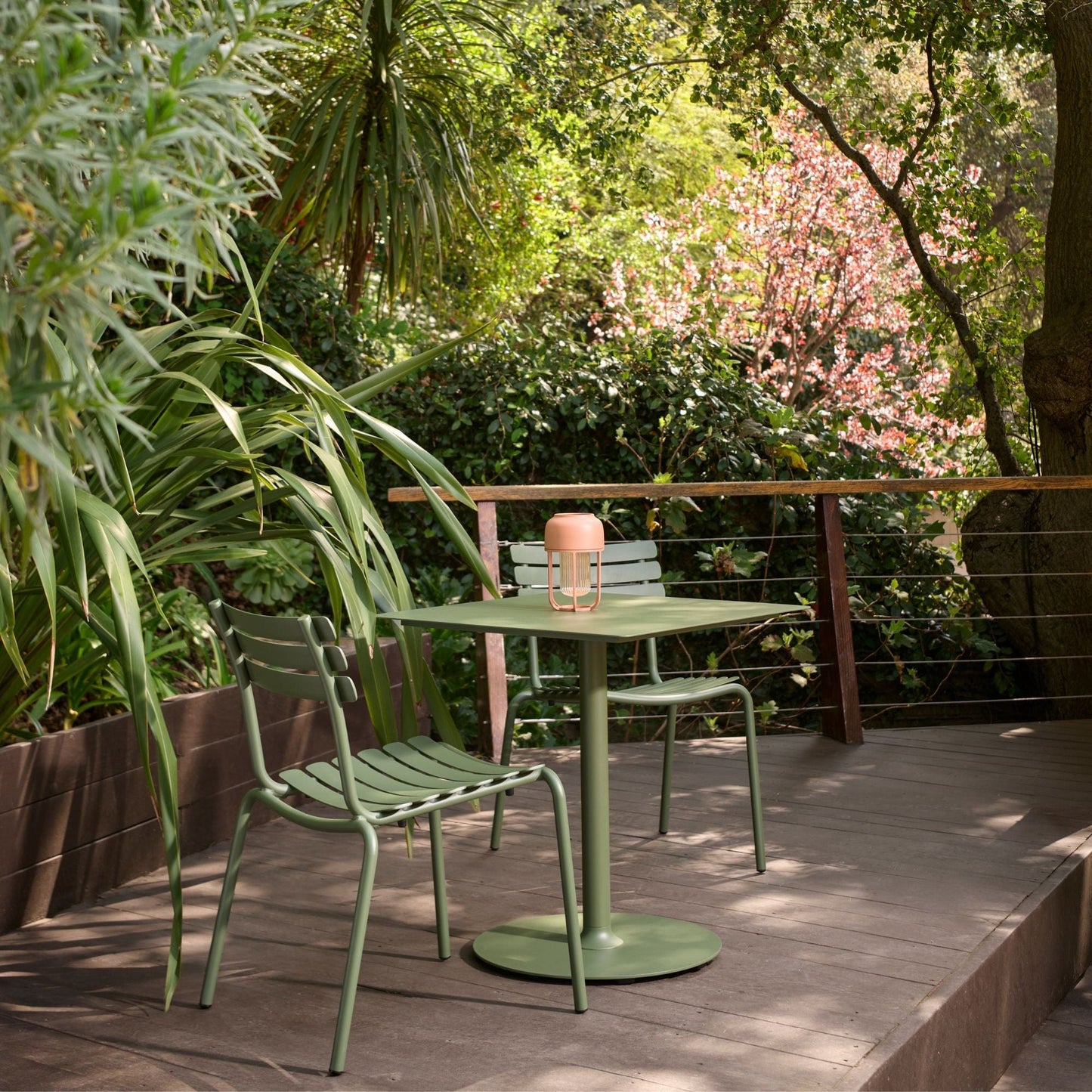 Green patio table and chairs with ALUA lamp