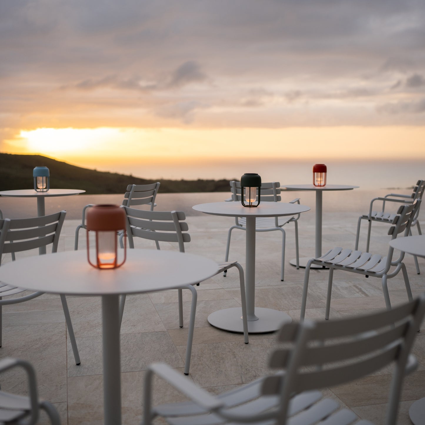 Pico Alua white lanterns on outdoor tables at sunset