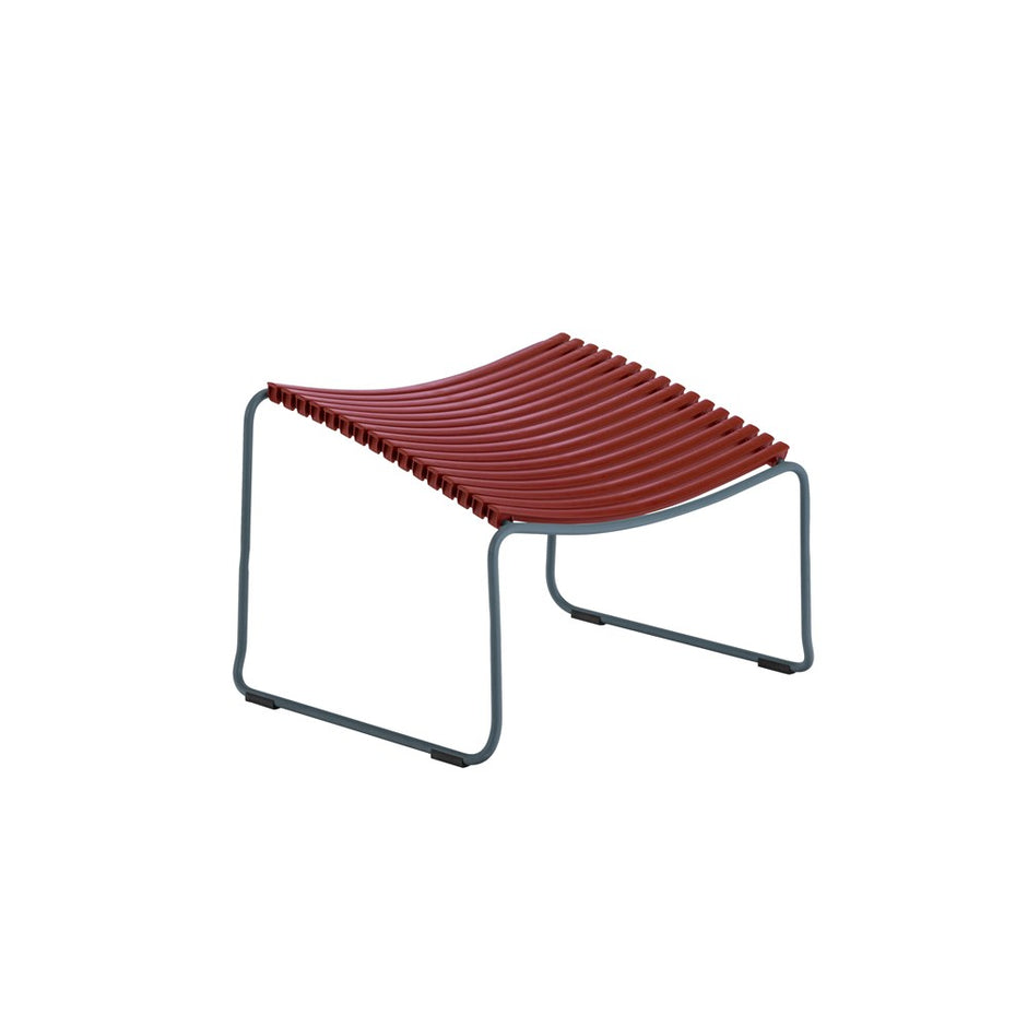 Red ribbed footstool with gray frame.
