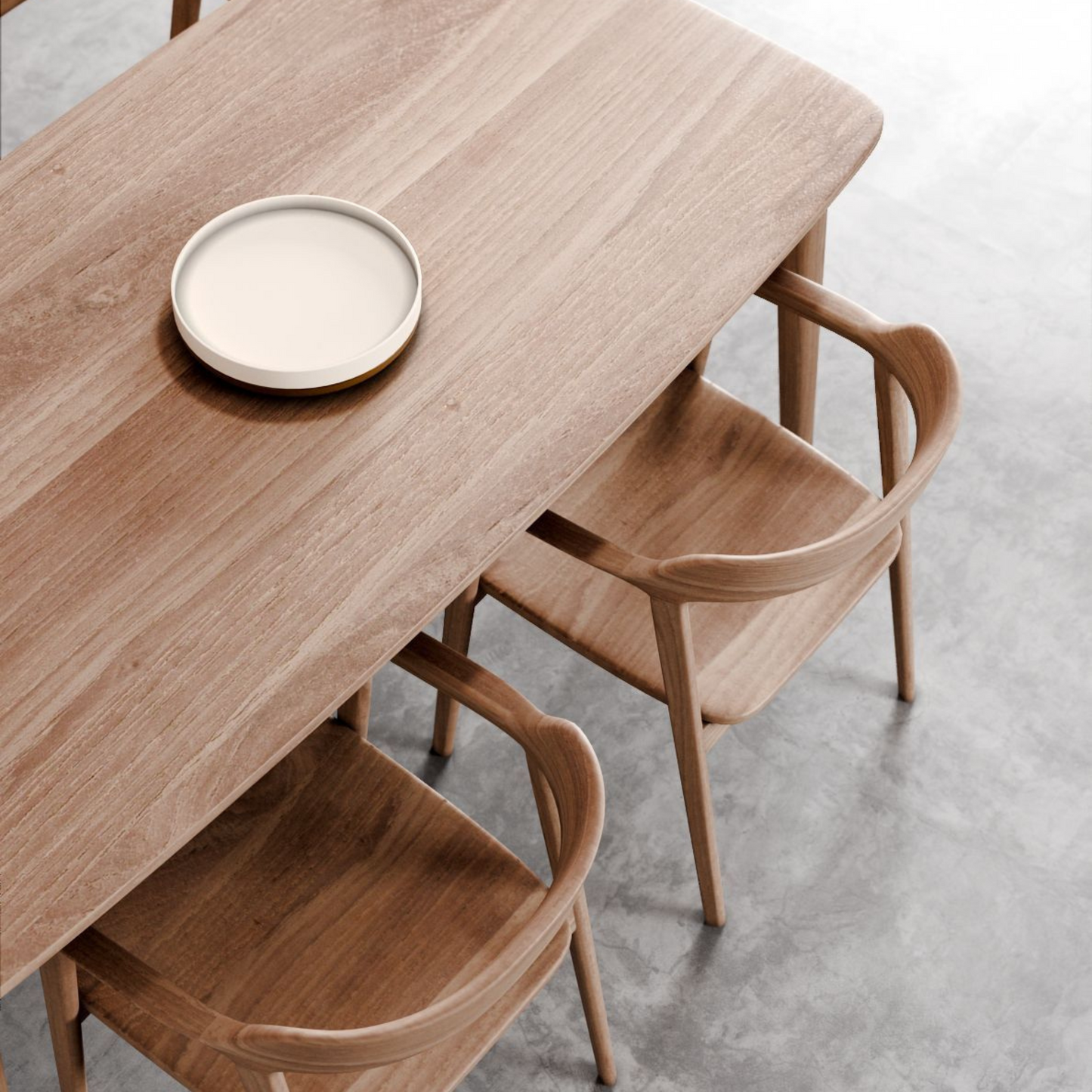 Wooden table with chairs and a plate.