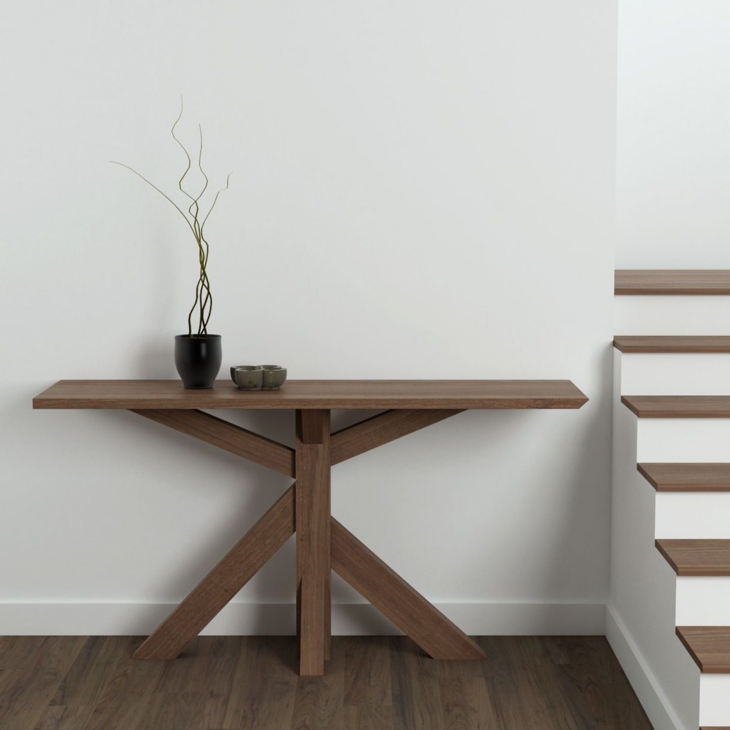 Wooden console table with decor next to stairs.