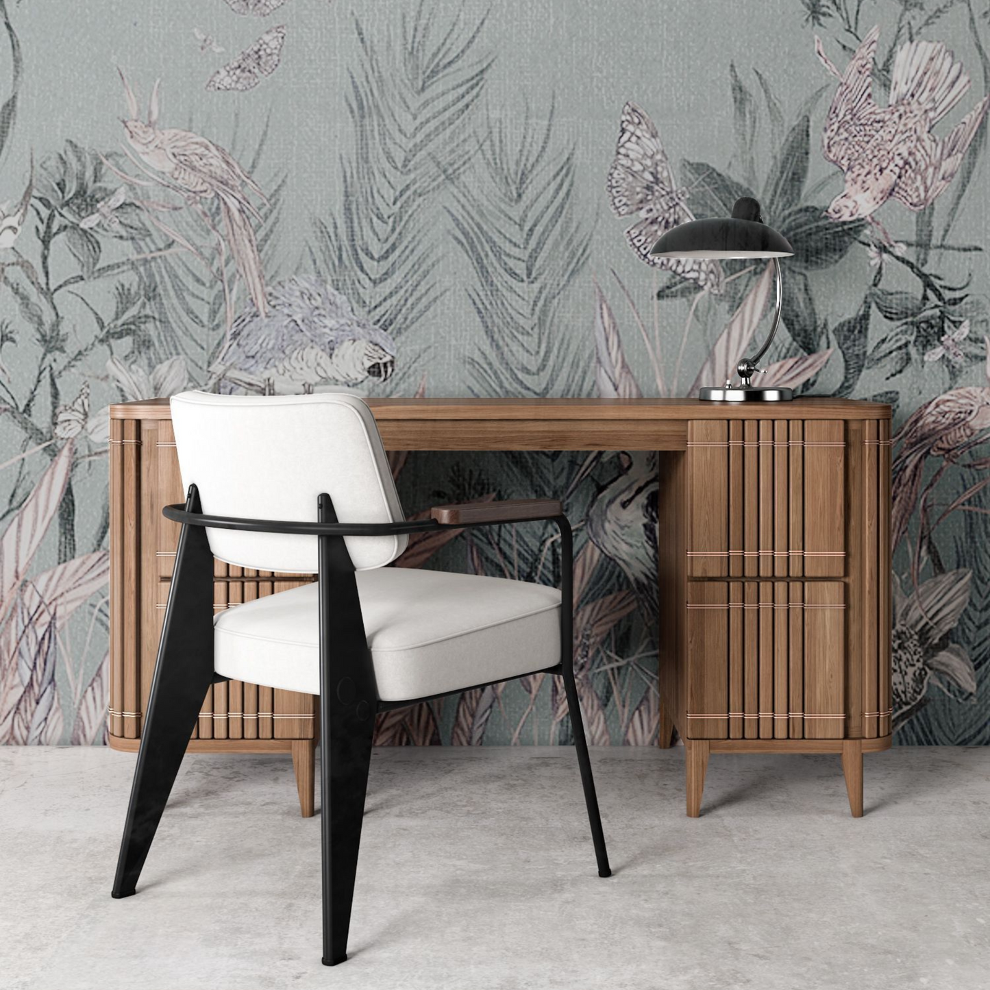Desk with chair and lamp in front of floral wallpaper.