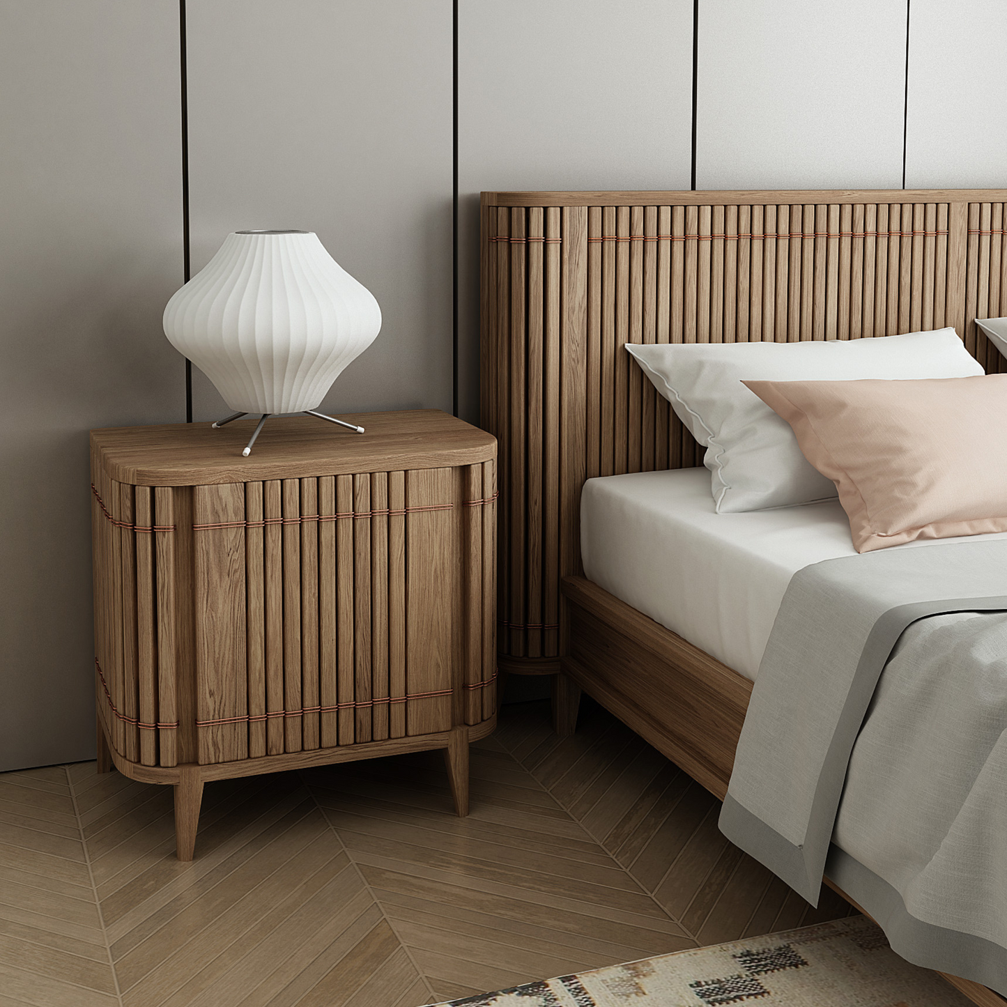 Wooden nightstand with lamp next to a bed.